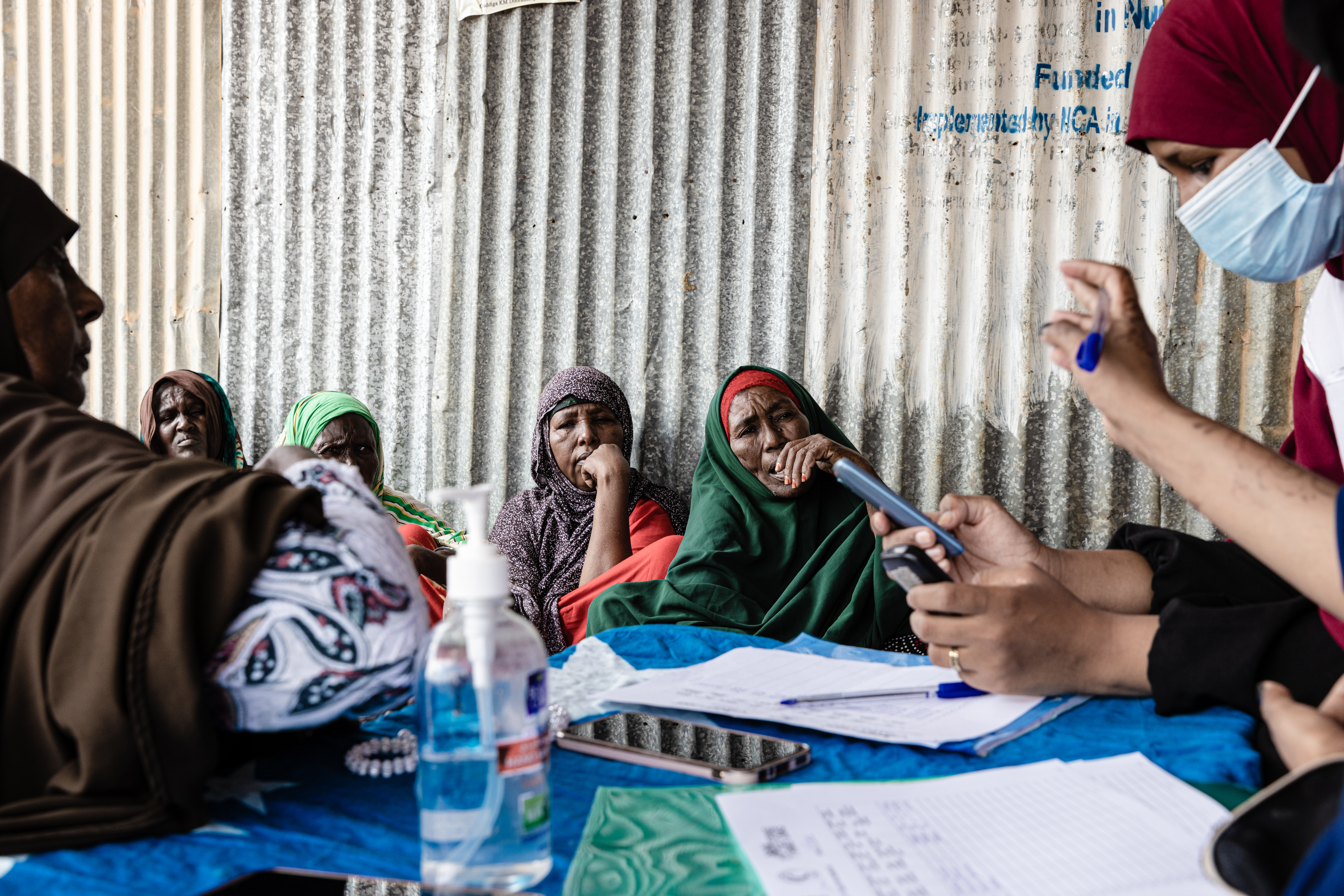 Red Crescent Society volunteers provide free phone calls in one of the camps for displaced people.