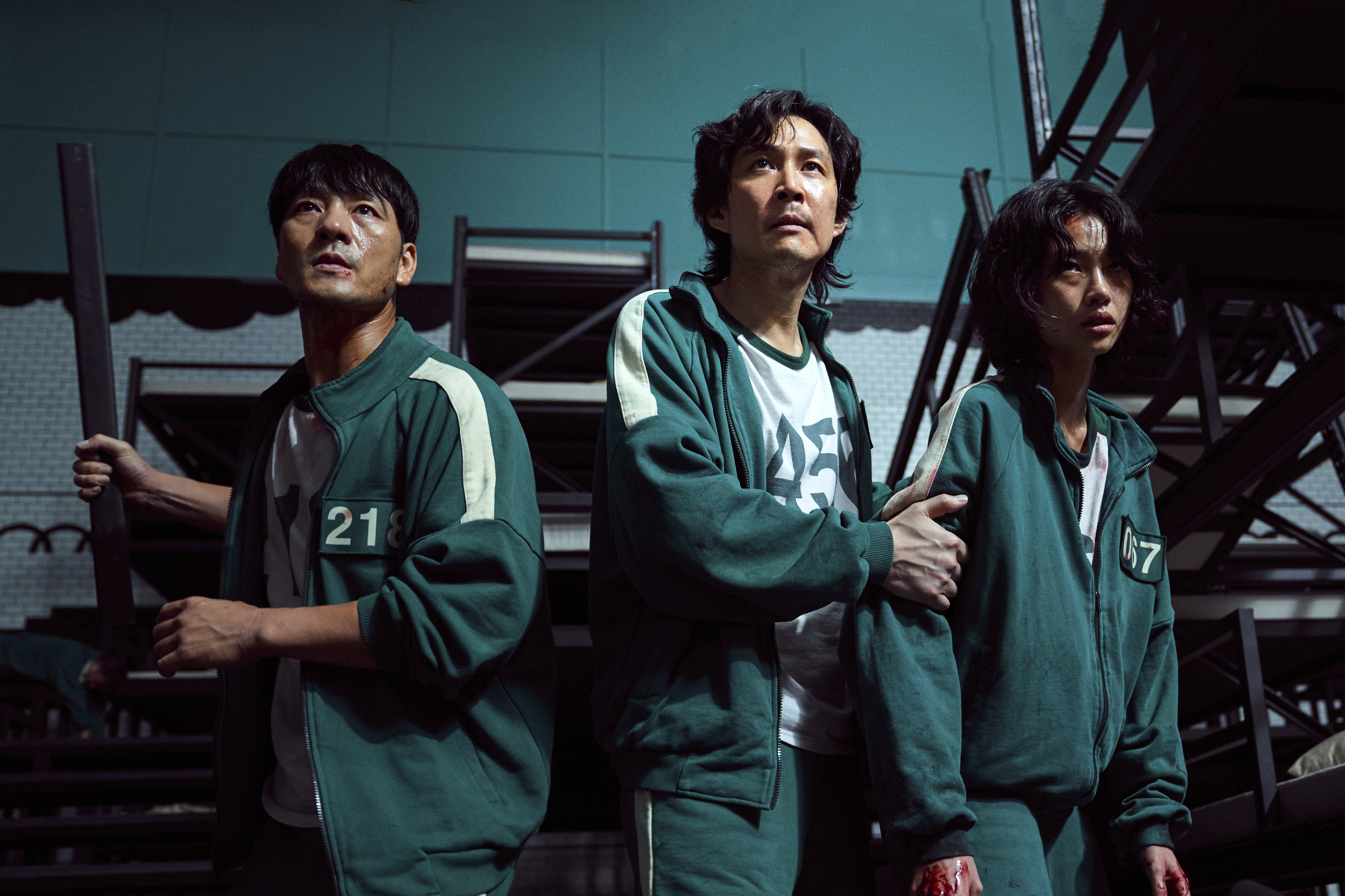 This undated photo released by Netflix shows South Korean cast members, from left, Park Hae-soo, Lee Jung-jae and Jung Ho-yeon in a scene from "Squid Game."