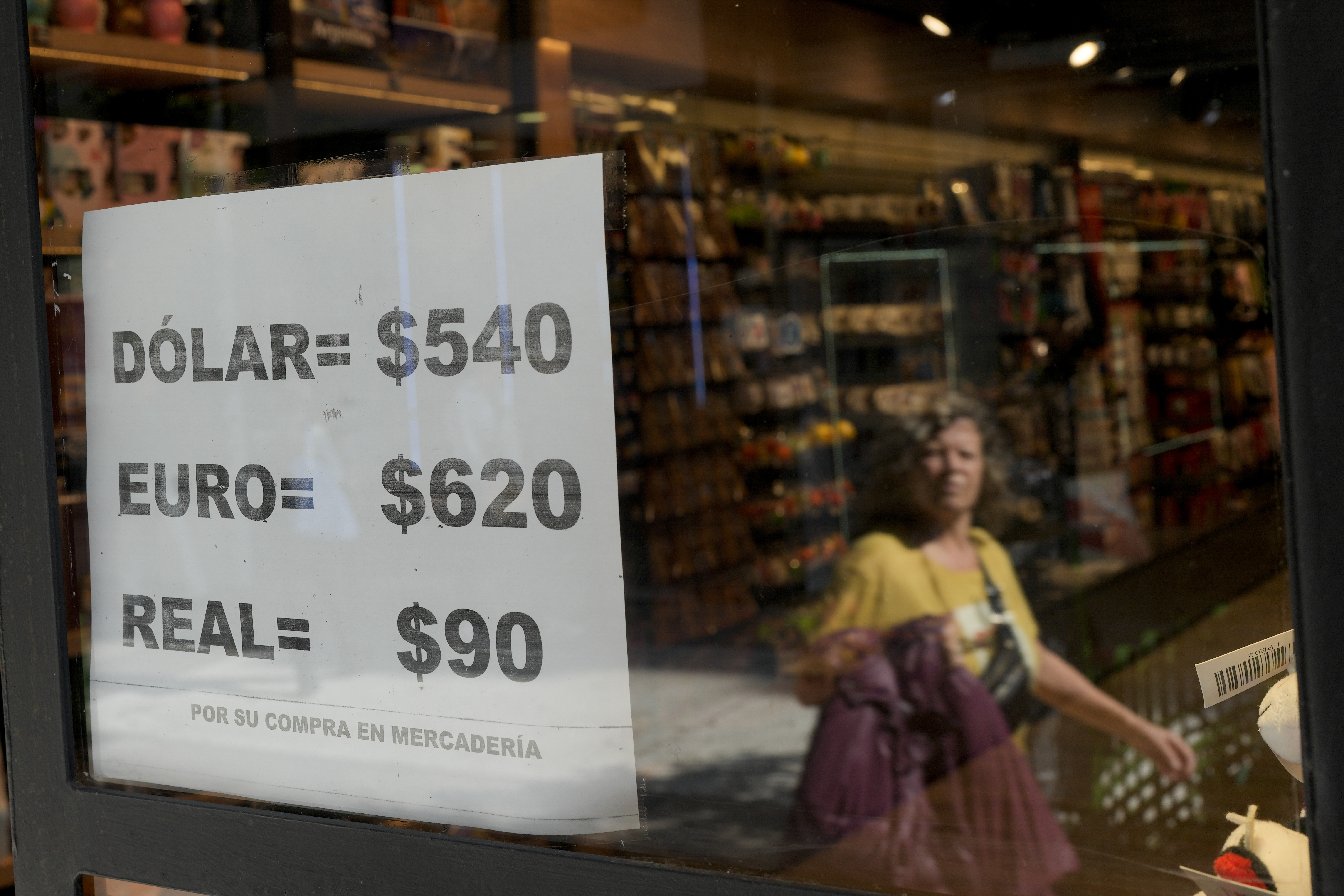 A shop displays on a sheet of paper unofficial currency exchange rates in Buenos Aires, Argentina