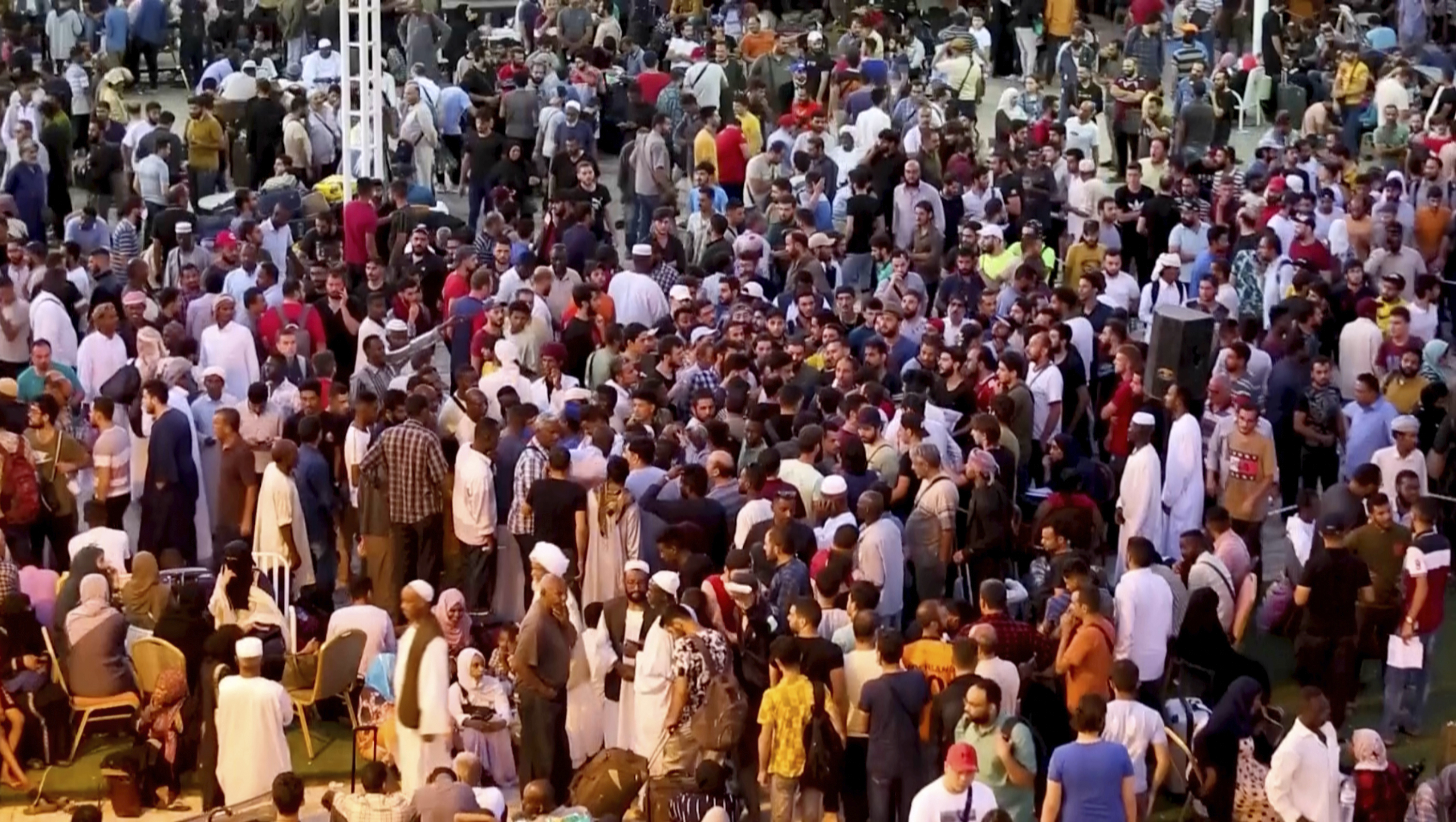 In this screen grab taken from video, Sudanese and foreigners arrive in Port Sudan
