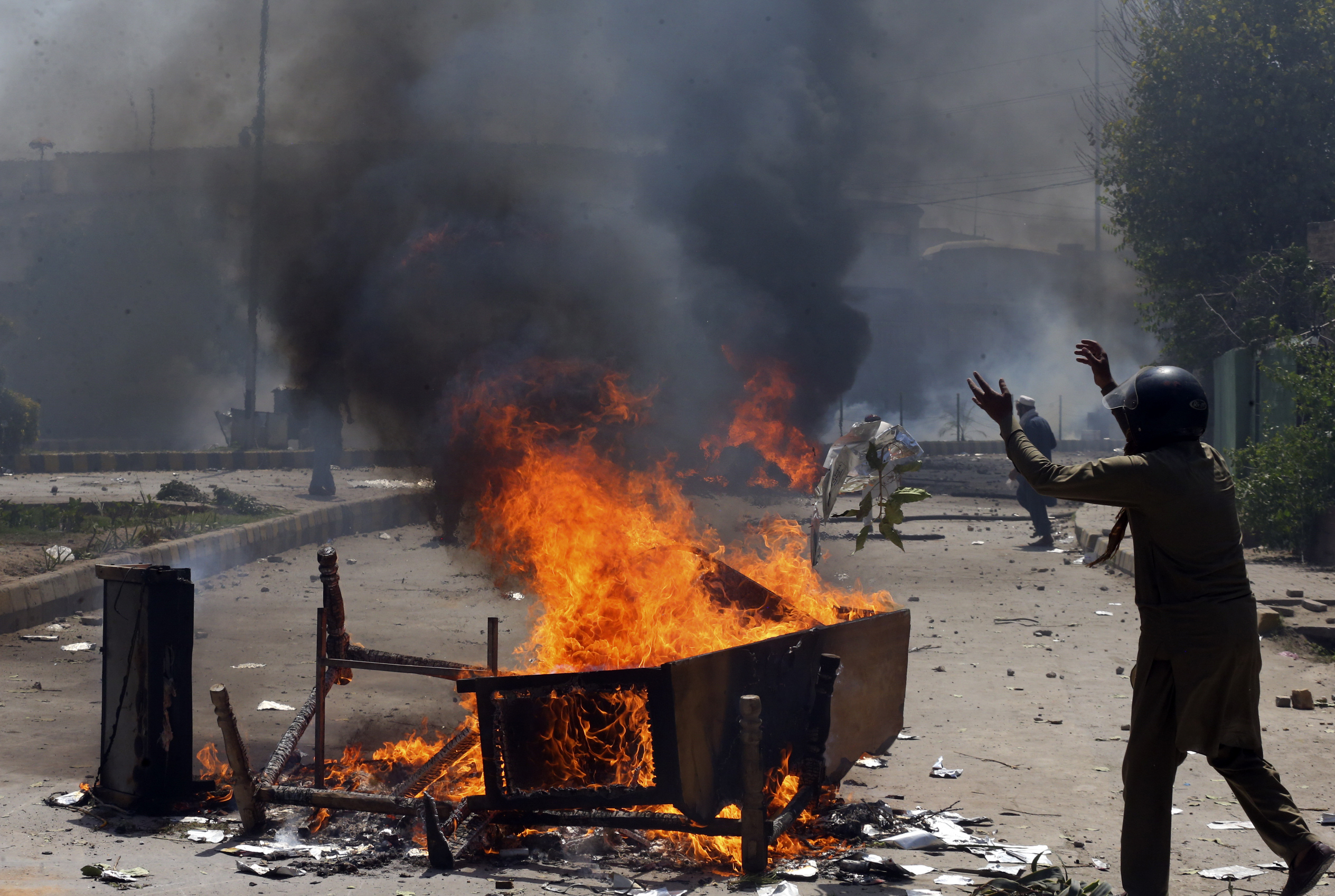 Supporters of Pakistan's former Prime Minister Imran Khan block a road as they protest against the arrest of their leader, in Peshawar, Pakistan, Wednesday, May 10, 2023. Pakistan braced for more turmoil a day after Khan was dragged from court in Islamabad and his supporters clashed with police across the country. The 71-year-old opposition leader is expected in court later Wednesday for a hearing on keeping Khan in custody. (AP Photo/Muhammad Sajjad)