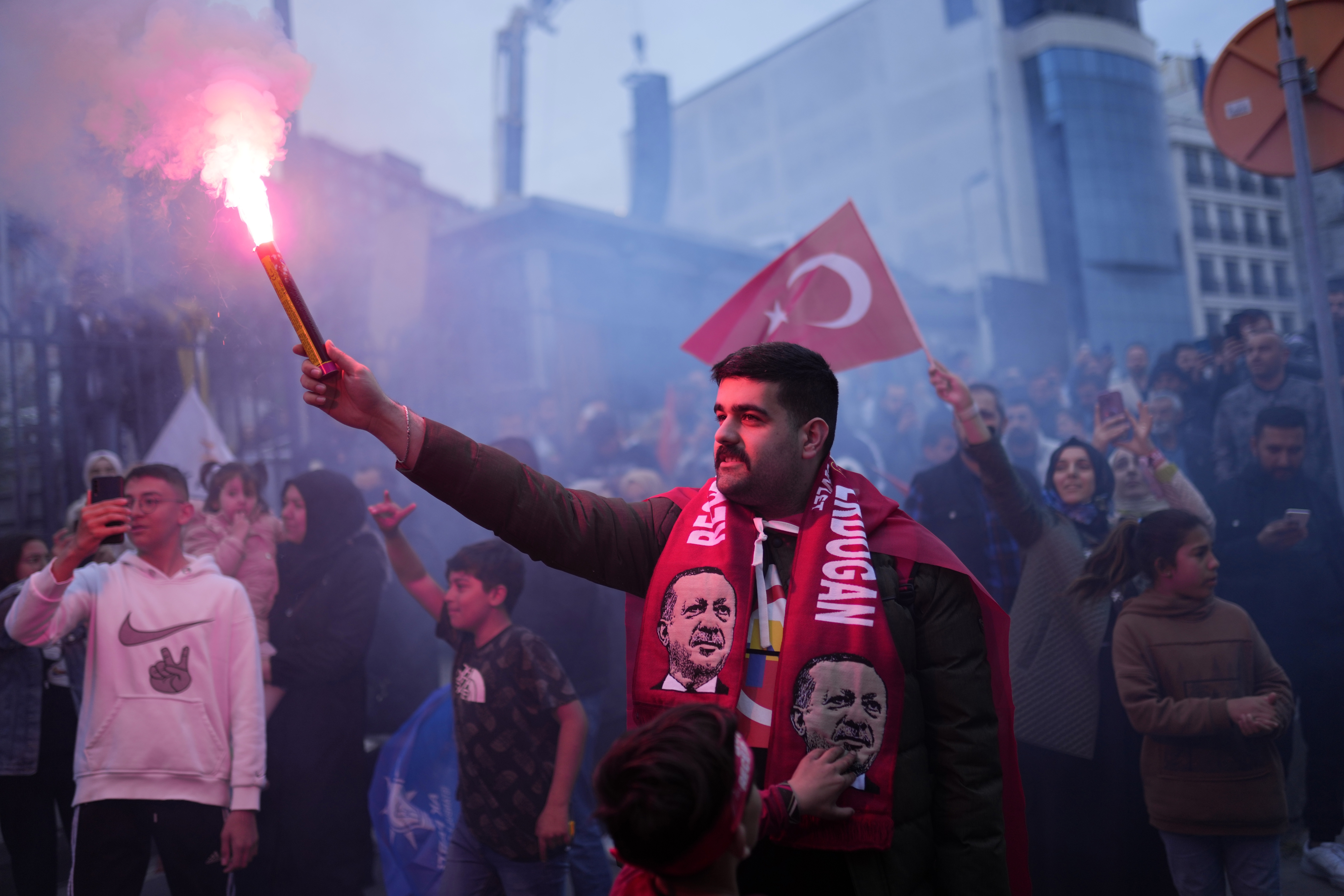 Supporters of President Recep Tayyip Erdogan cheer outside the headquarters of AK Party in Istanbul