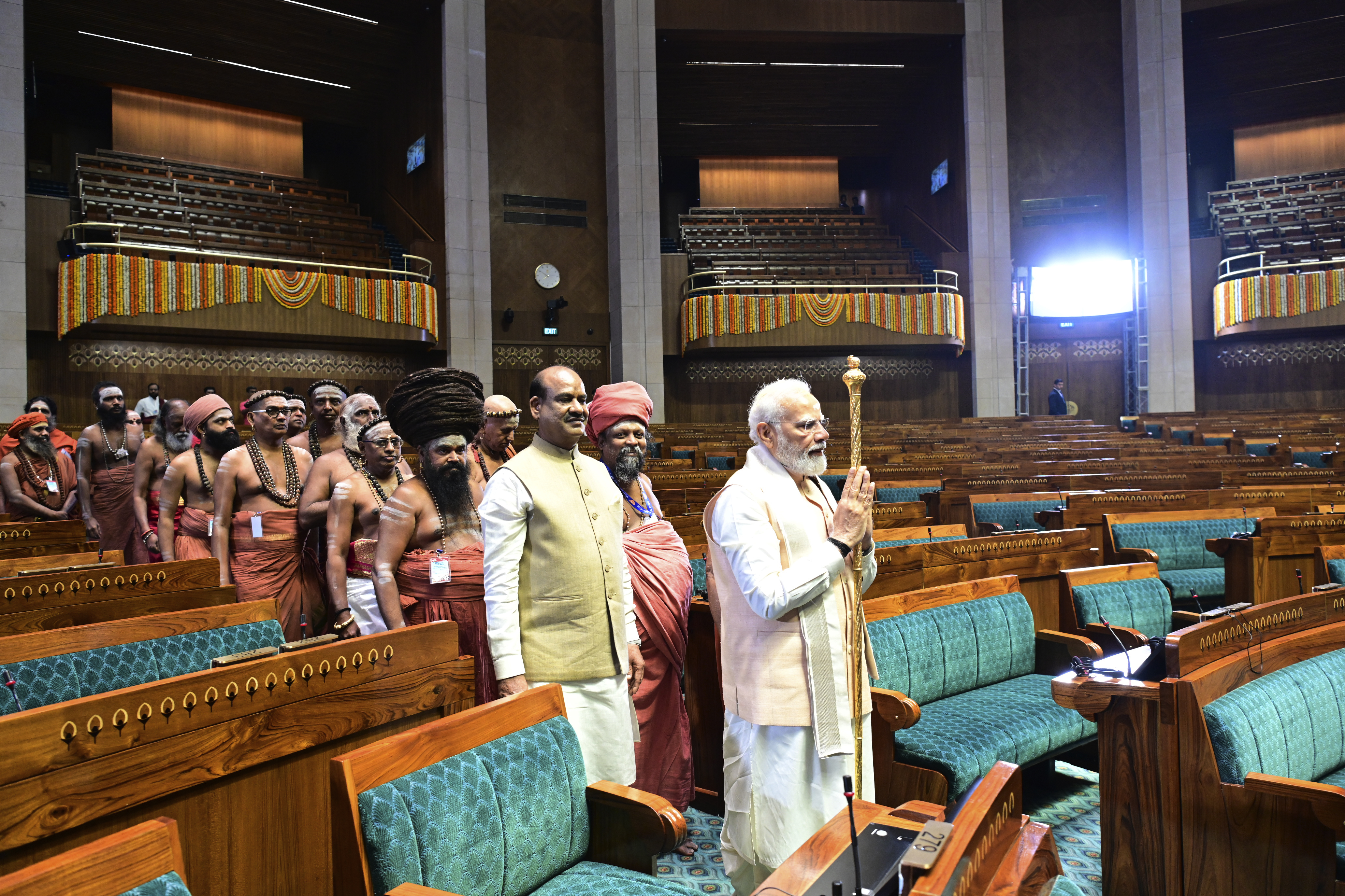 Indian prime minister Narendra Modi carries a royal golden sceptre to be installed it near the chair of the speaker during the start of the inaugural ceremony of the new parliament building, in New Delhi, India, Sunday, May 28