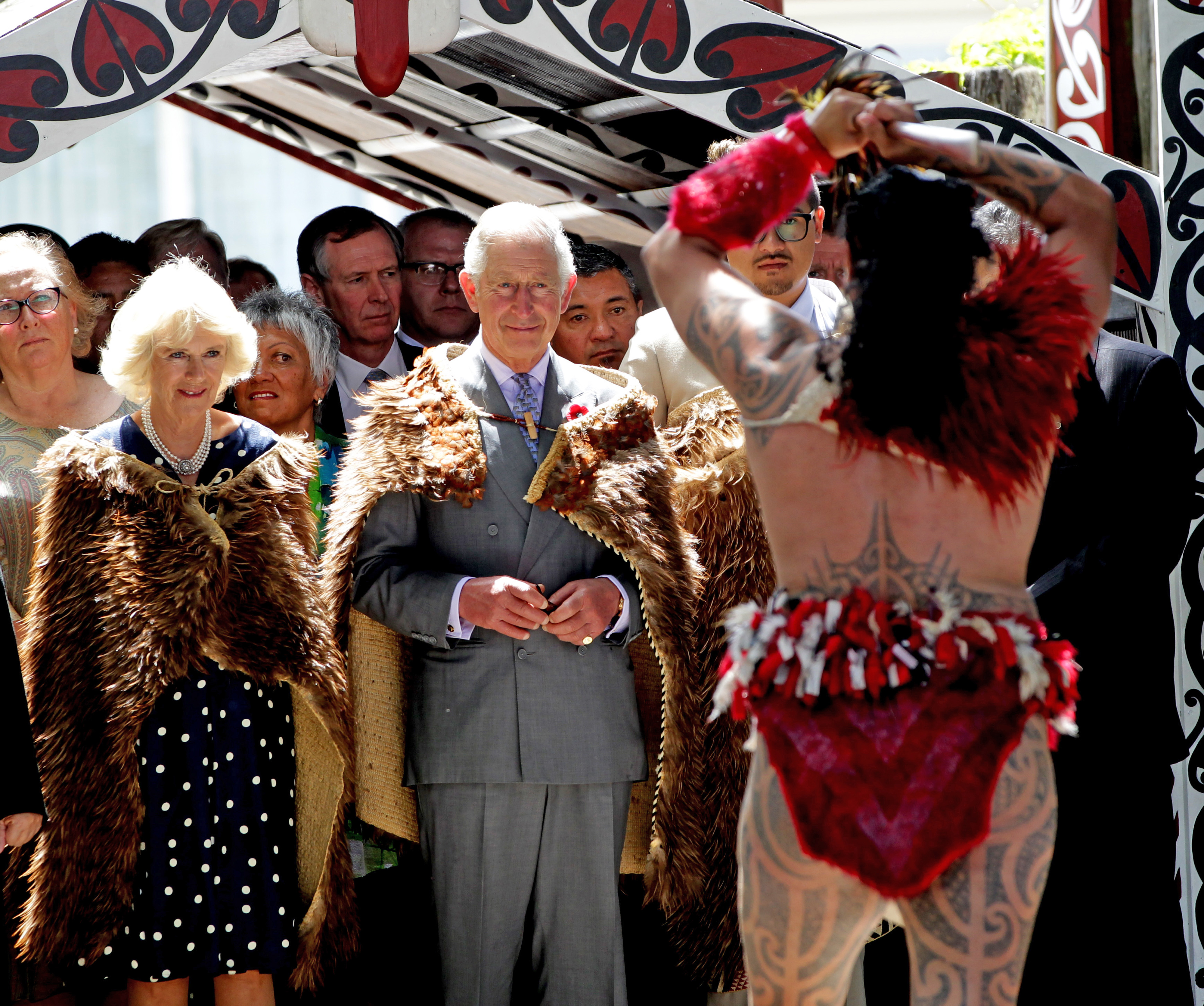 Charles and Camilla on a visit to New Zealand in 2015. They are wearing Maori capes and watching a traditional Maori welcome.