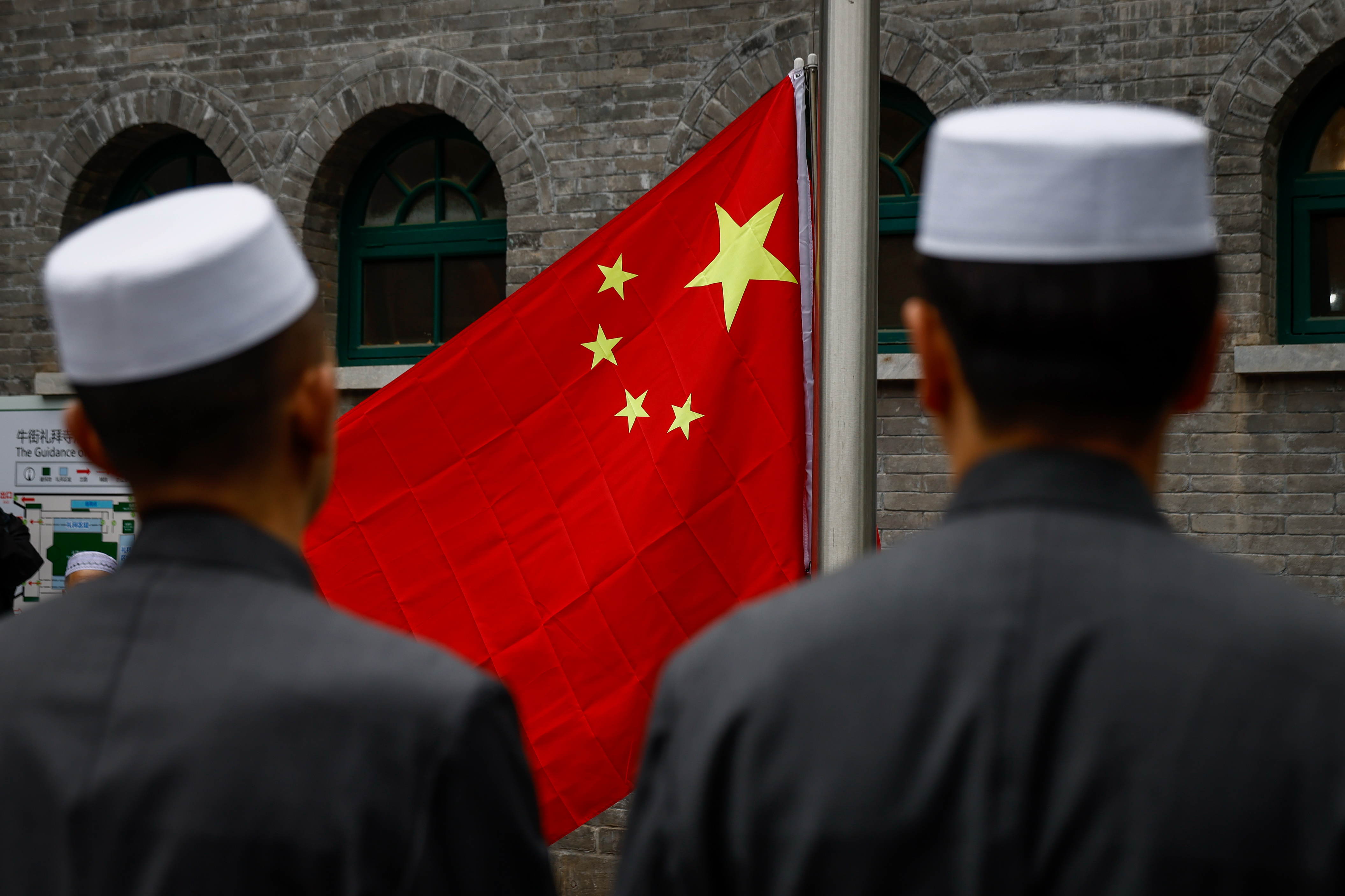 Muslims attend a flag-raising ceremony before prayers to mark Eid al-Fitr at the Niujie Mosque in Beijing in April