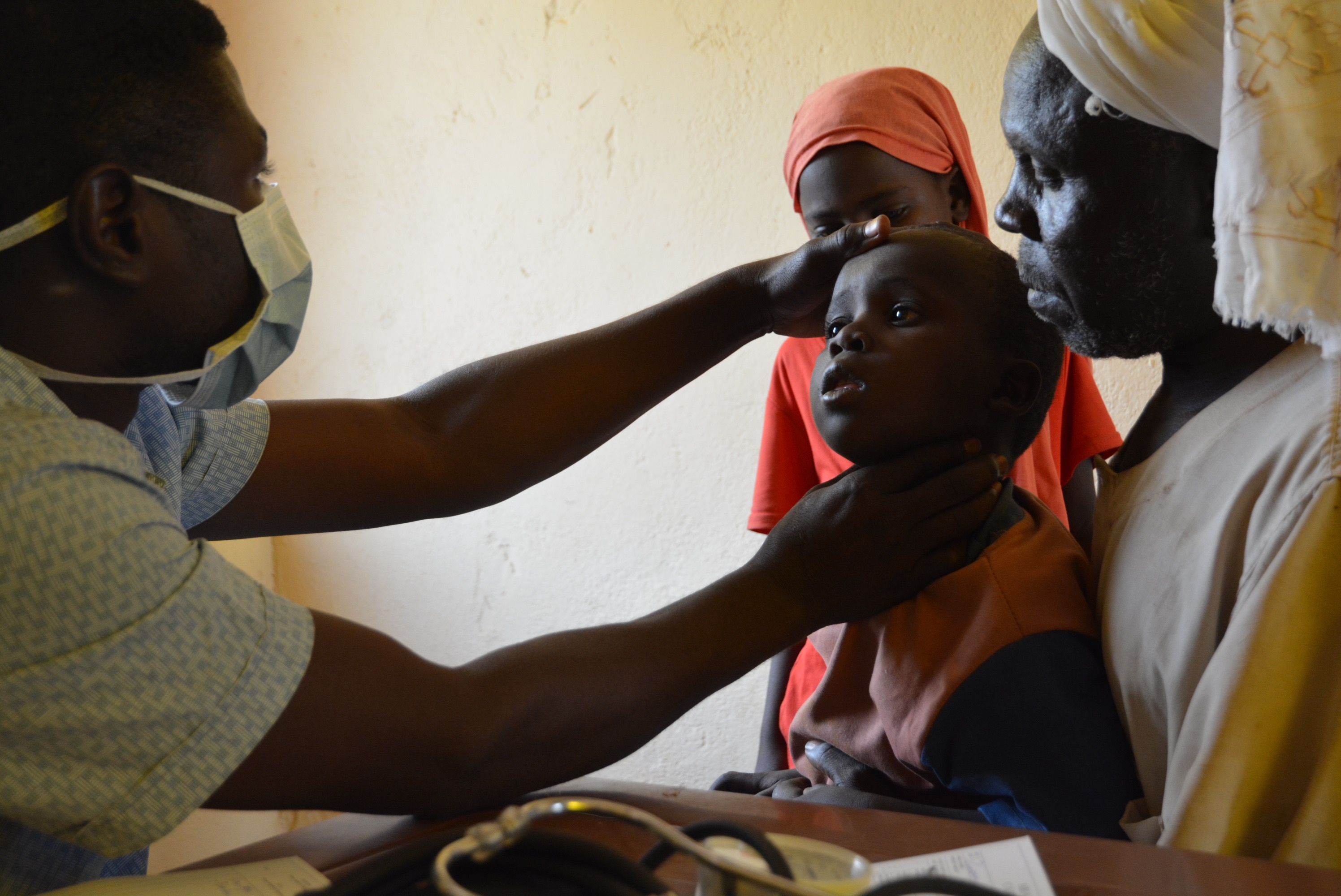 A doctor treats a child in Sudan