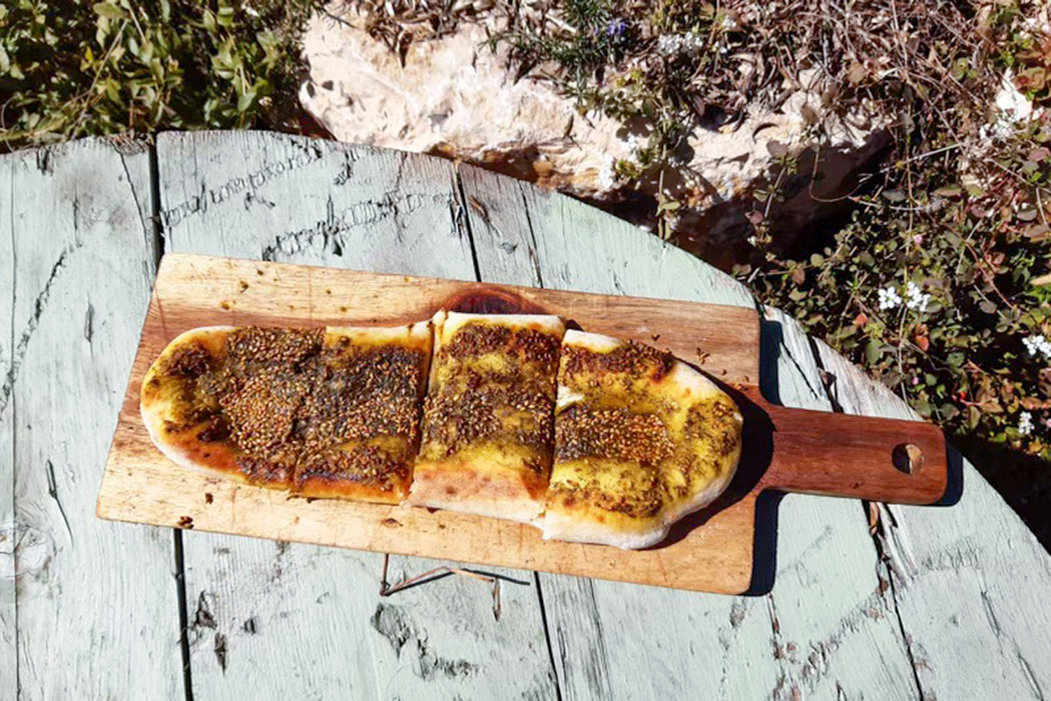a zaatar manouche on a wooden board