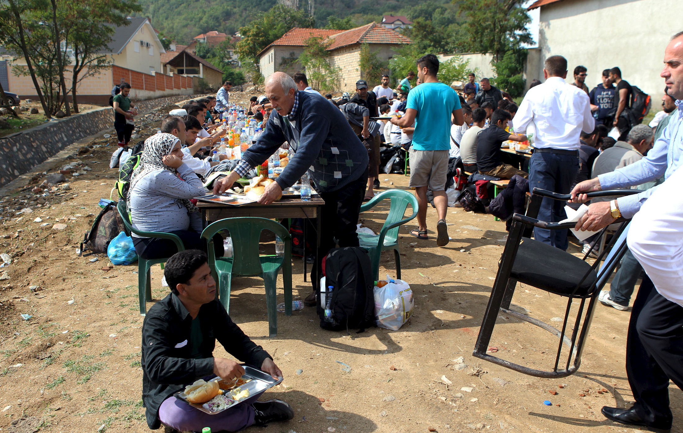 Migrants have lunch offered to them for the celebration of Eid-al-Adha in the village of Miratovac near the town of Presevo, southern Serbia