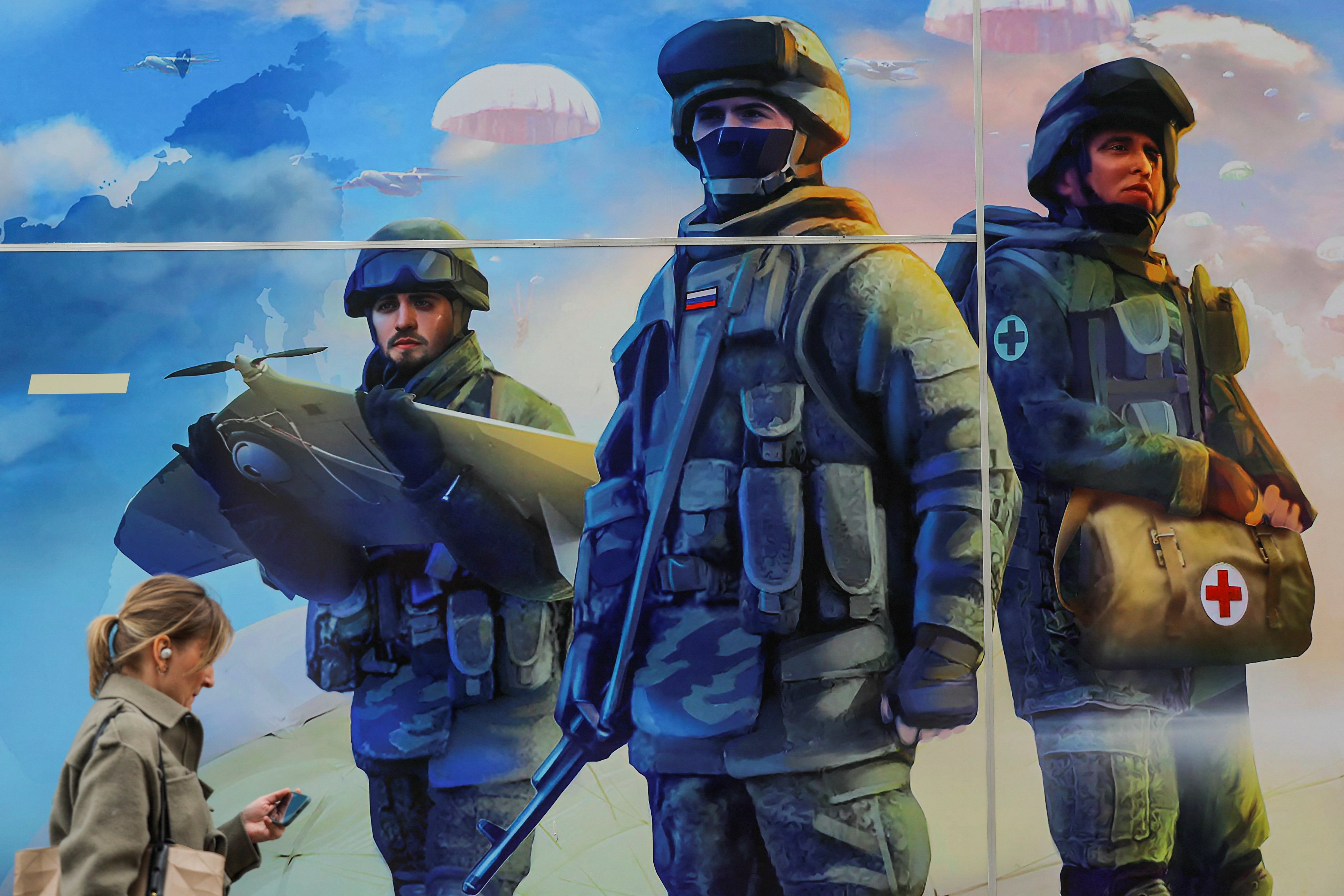 A pedestrian walks past a mobile recruitment point located to promote service in the Russian army and invite volunteers to sign a contract with the defence ministry, in a street in Moscow, Russia, May 3, 2023. REUTERS/Evgenia Novozhenina