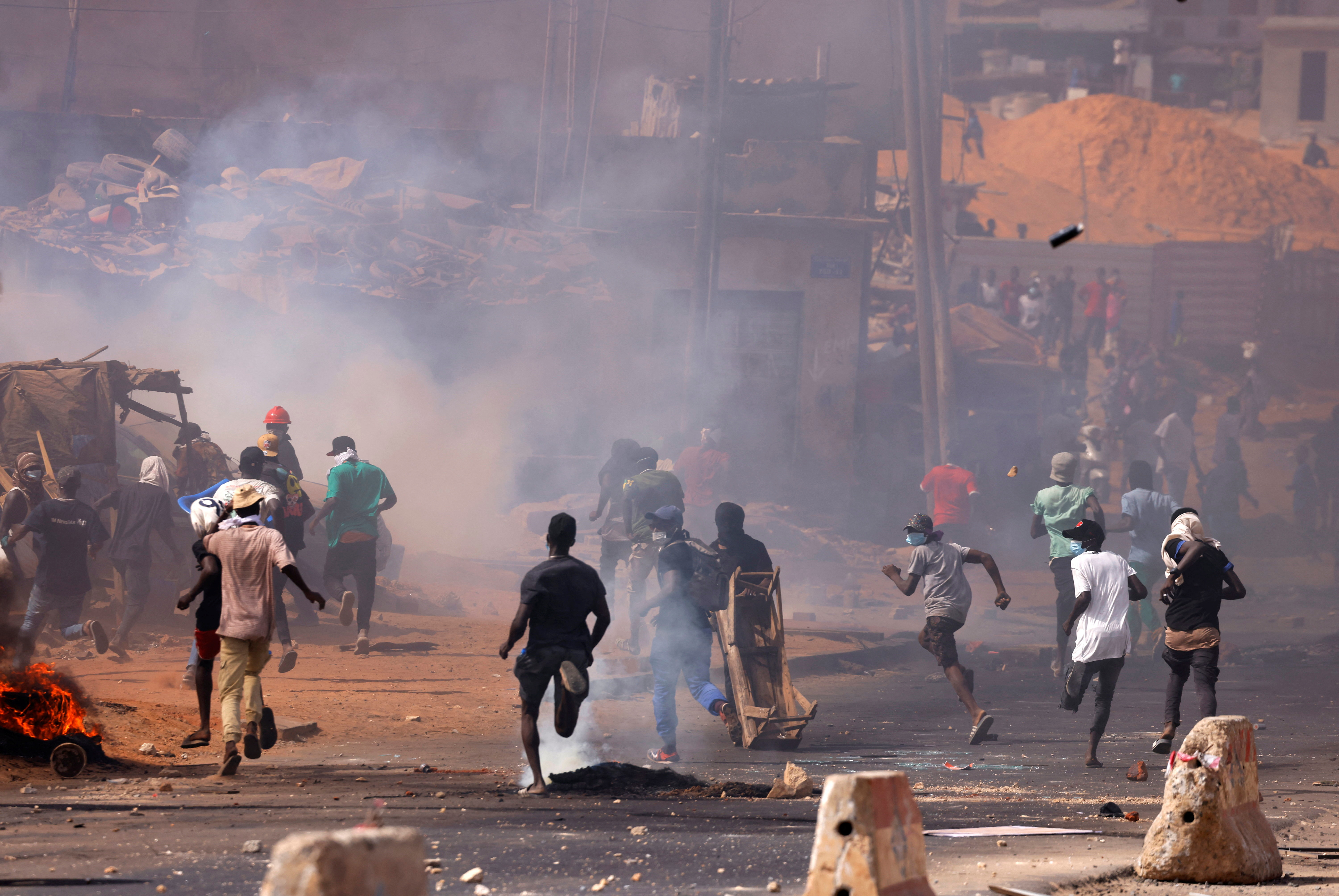 Supporters of Senegal opposition leader Ousmane Sonko run away as they clash with security forces, after Sonko was sentenced to prison in Dakar, Senegal June 2, 2023