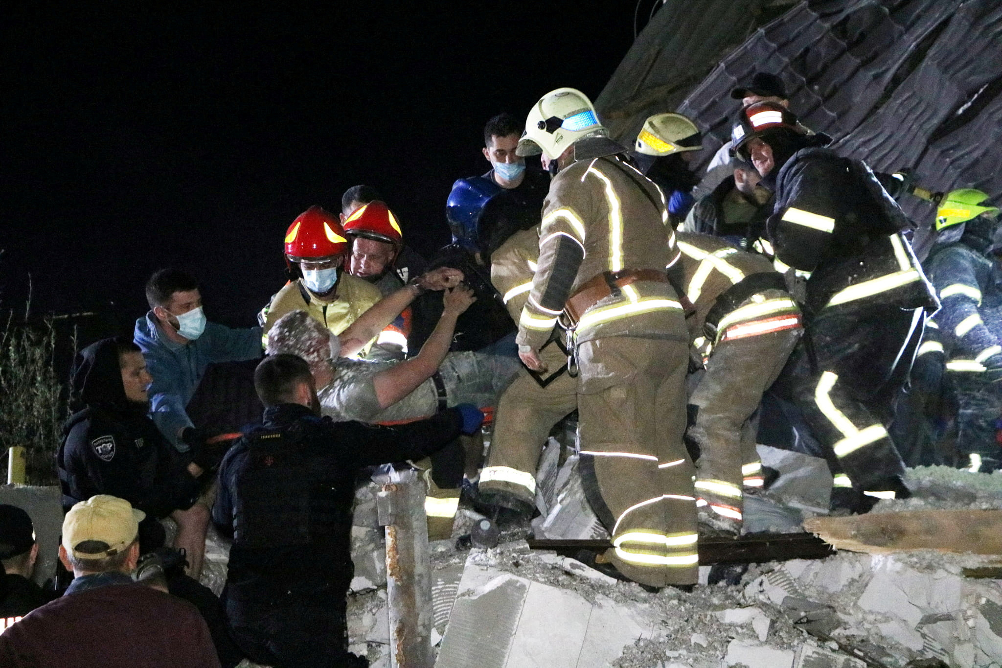 Emergency workers rescue a man from debris of a residential building heavily damaged by a Russian missile strike on outskirt of the Dnipro city, Ukraine June 3, 2023