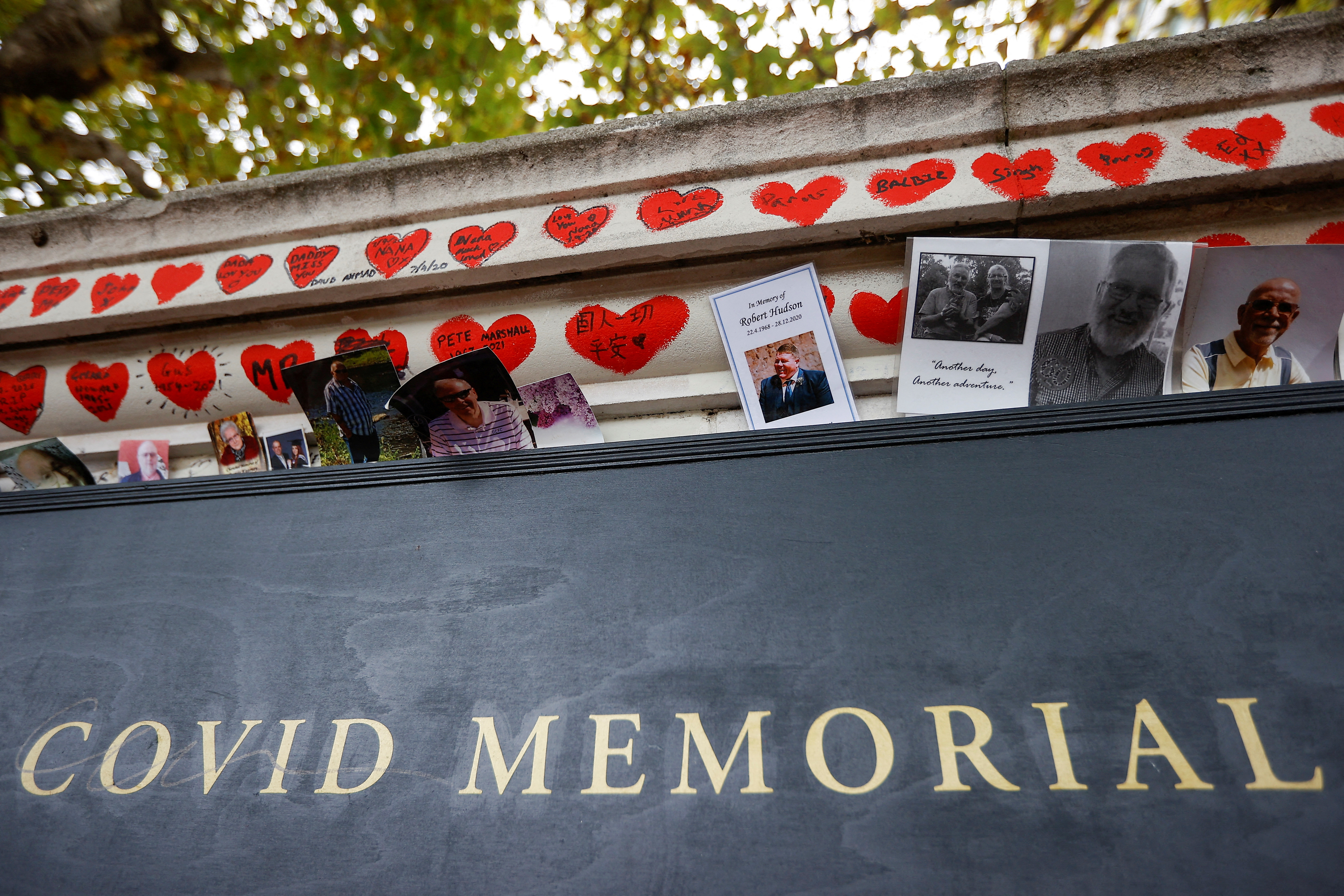 Photographs are left at the National Covid Memorial Wall