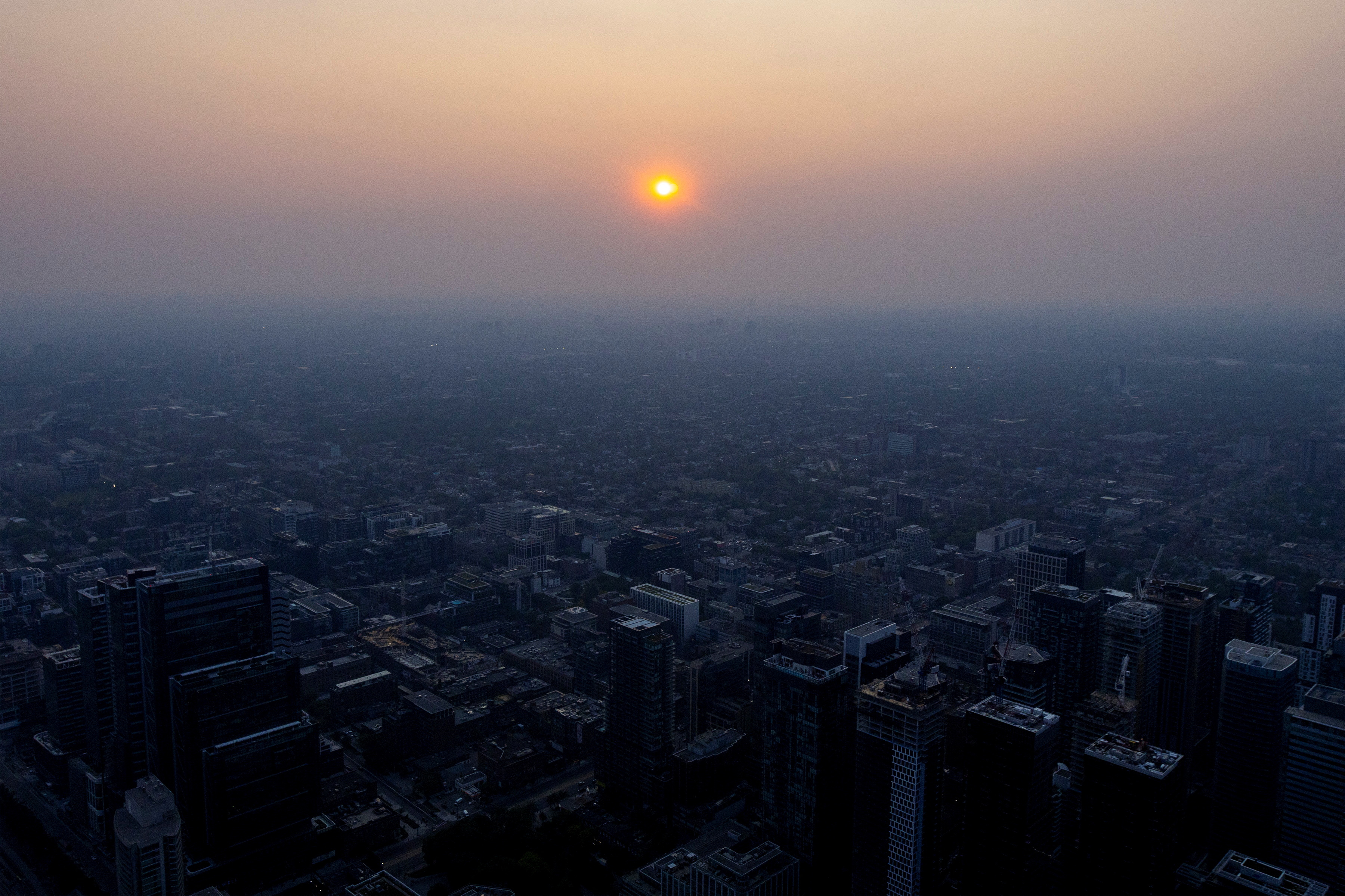 A smoky Toronto skyline is seen with a blanket of smoke due to wildfires