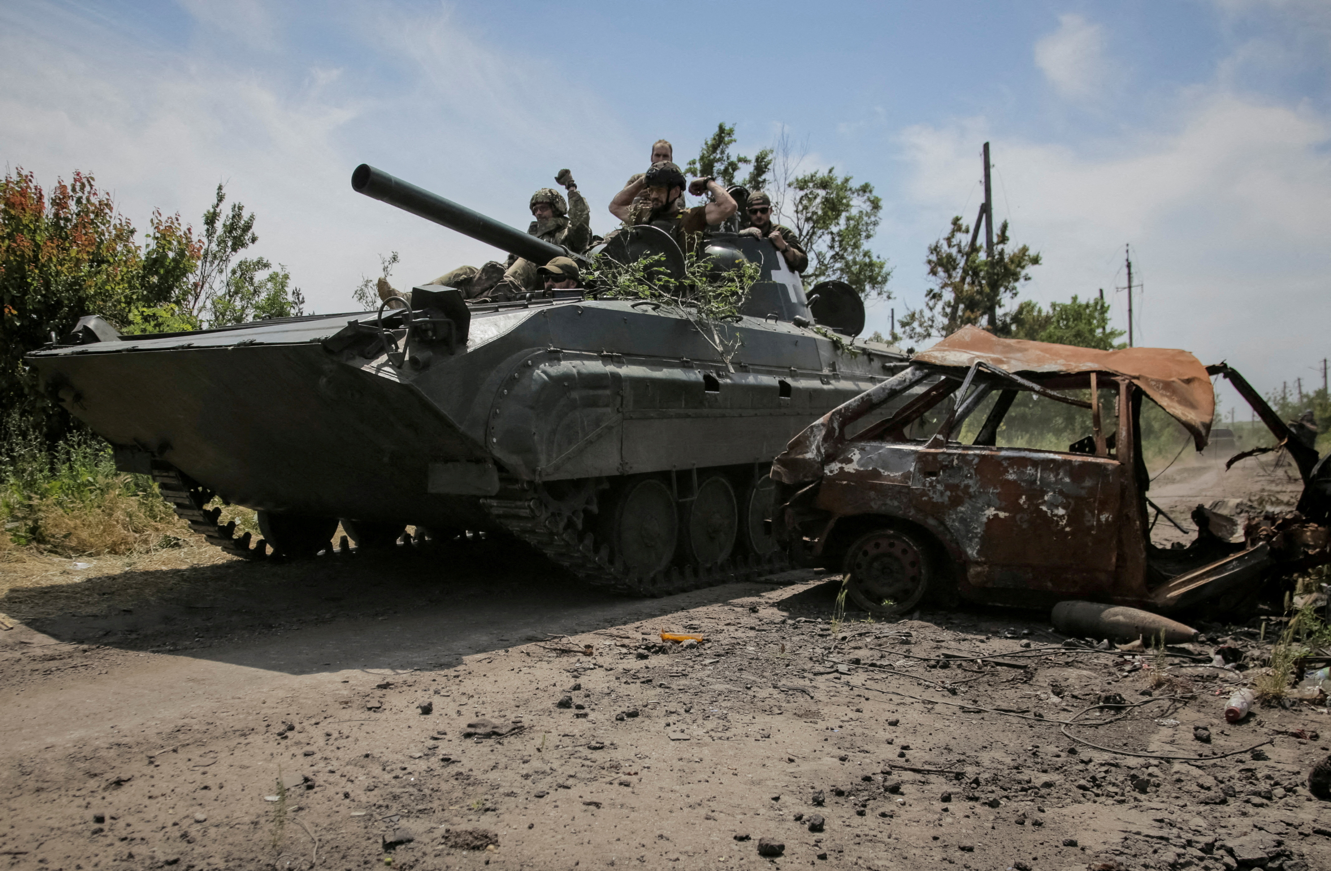 FILE PHOTO: Ukrainian service members ride a BMP-1 infantry fighting vehicle, amid Russia's attack on Ukraine, near the front line in the newly liberated village Neskuchne in Donetsk region, Ukraine June 13, 2023. REUTERS/Oleksandr Ratushniak/File Photo