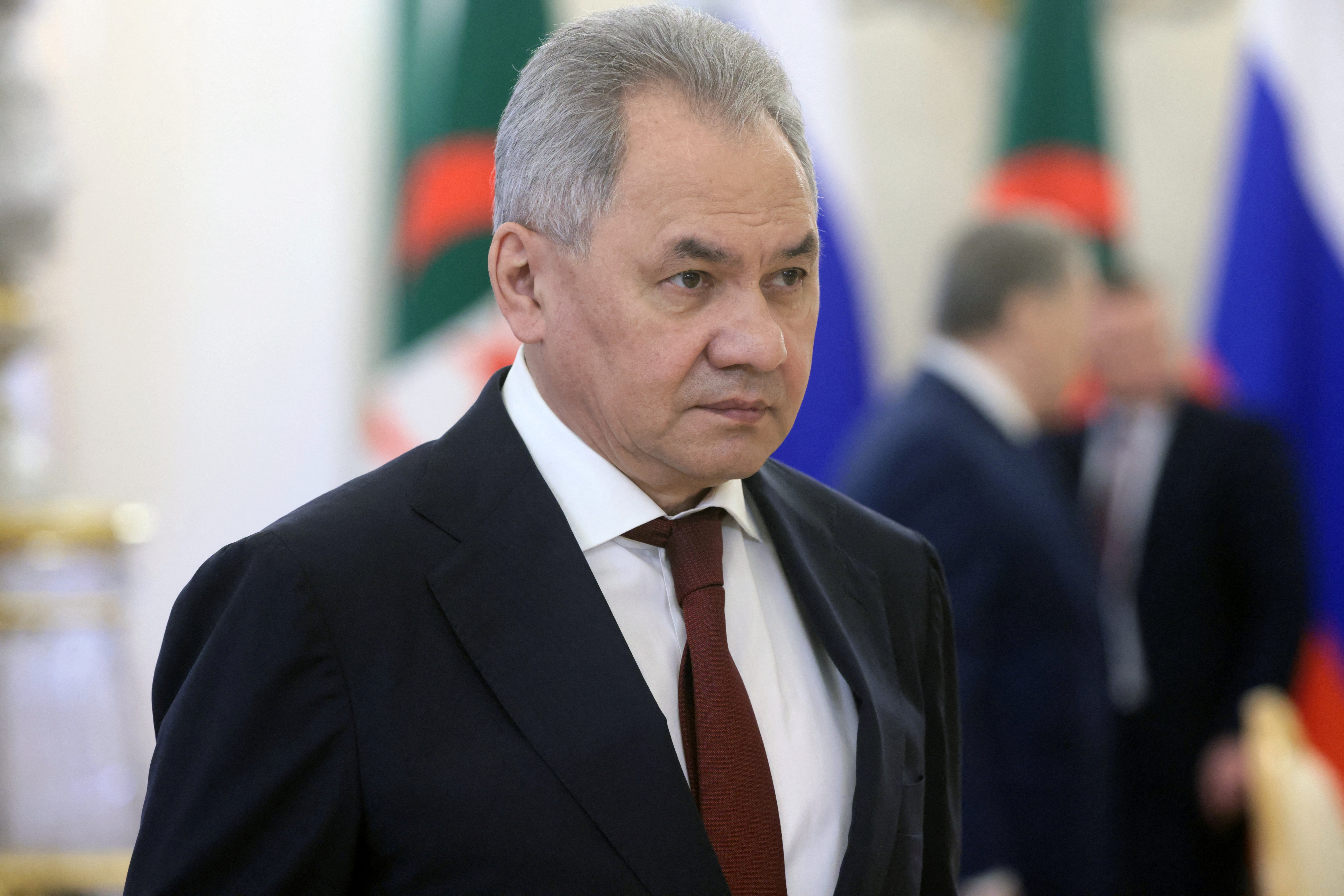 A man in a dark suit and red tie attends a meeting at the Kremlin in Moscow, Russia