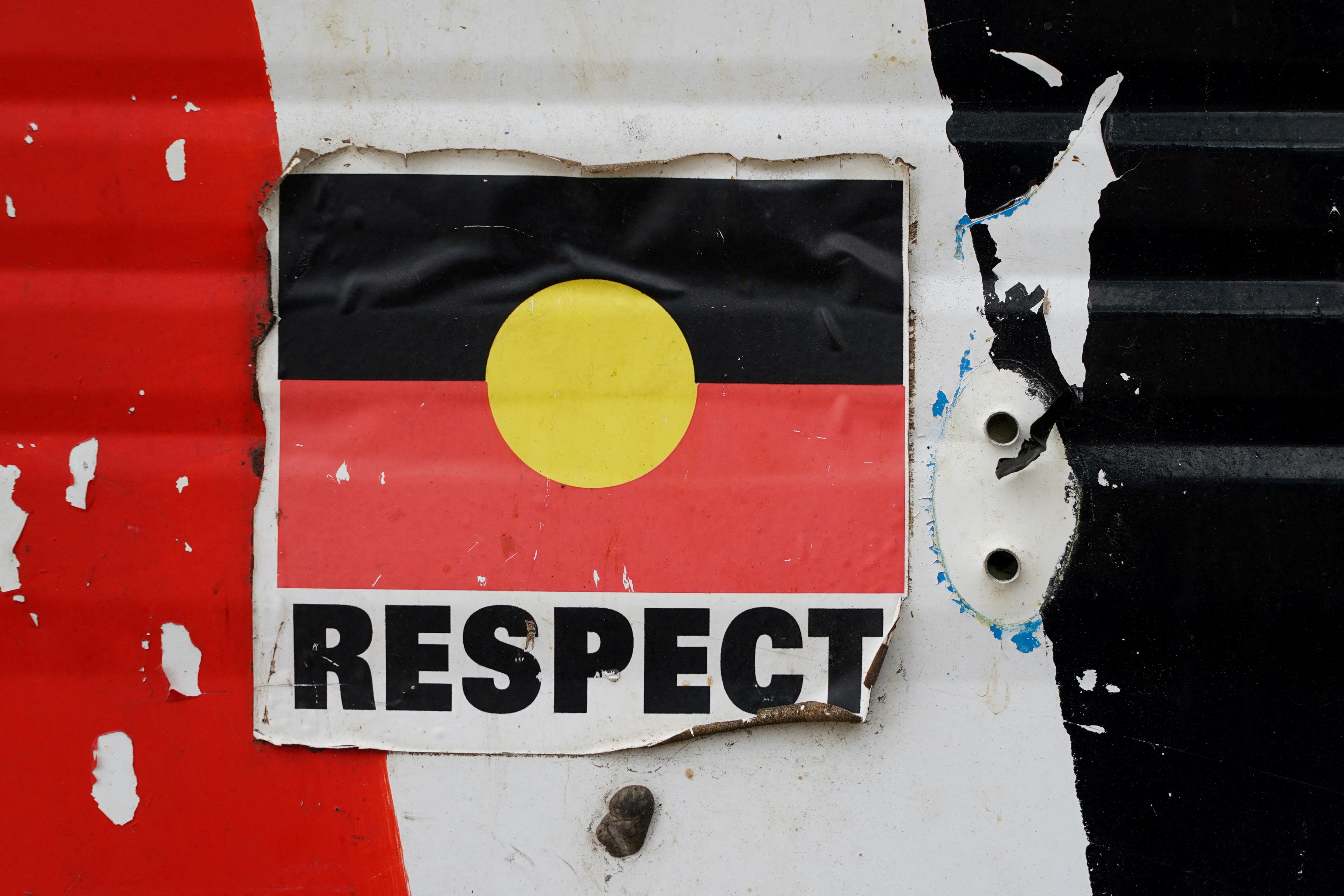A sticker of the Australian Aboriginal Flag with the word 'Respect' below