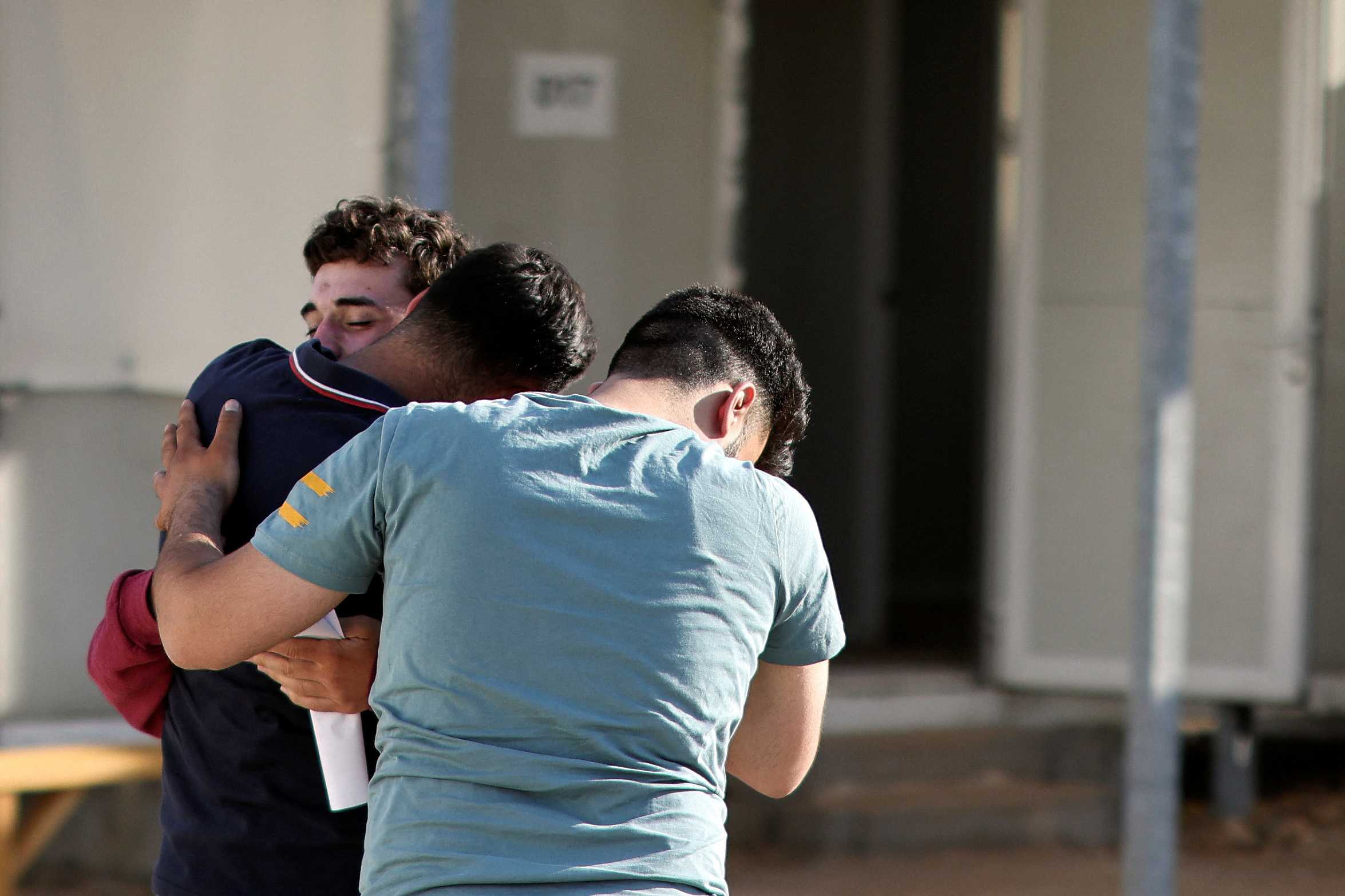Syrian survivor Mohammad, 18, who was rescued with other refugees and migrants at open sea off Greece after their boat capsized, reunites with his brother Fadi, inside a reception and identification camp in Malakasa, Greece, June 18, 2023. REUTERS/Stelios Misinas