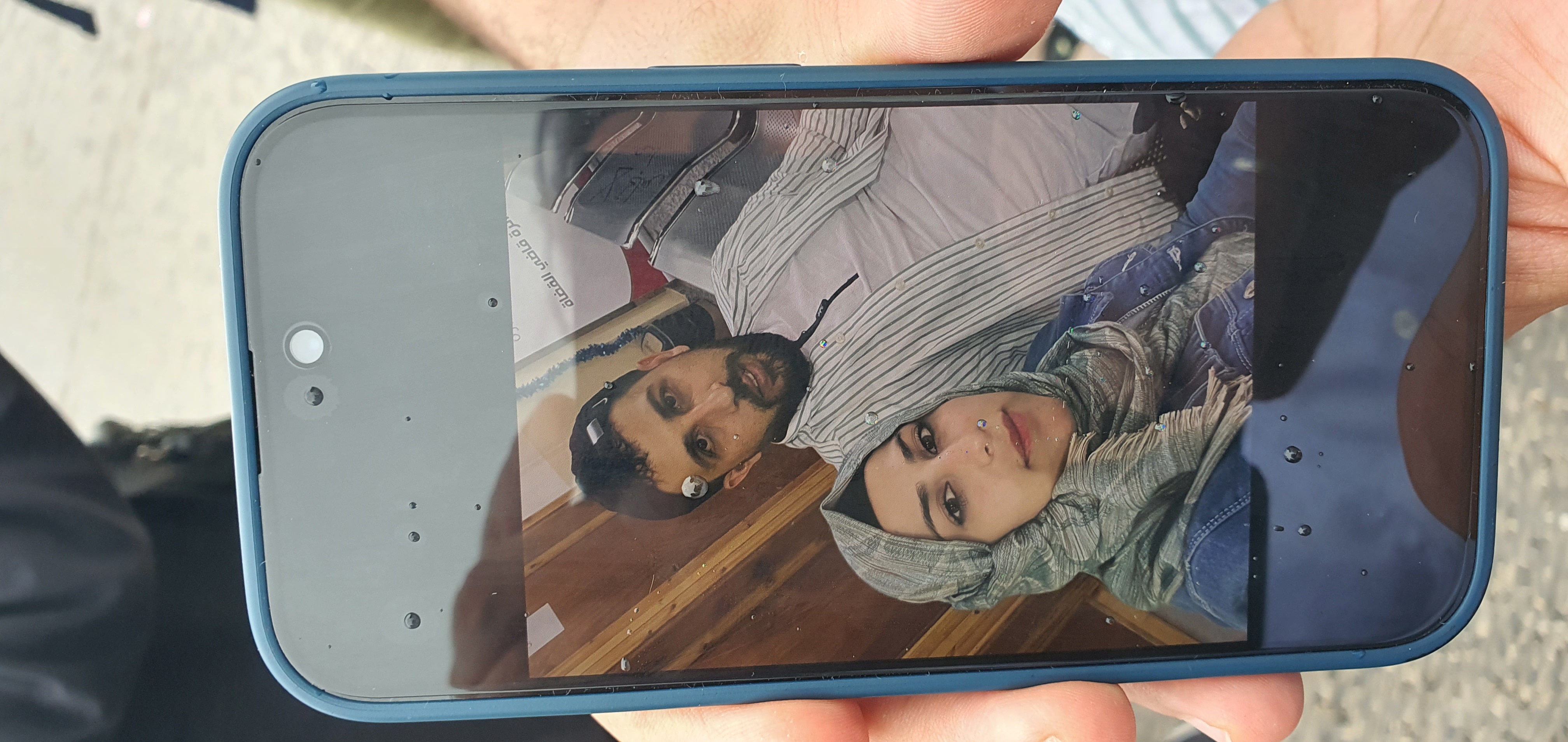 Kassem Abuzeed shows a photo of himself with his wife, Ezra Aboud