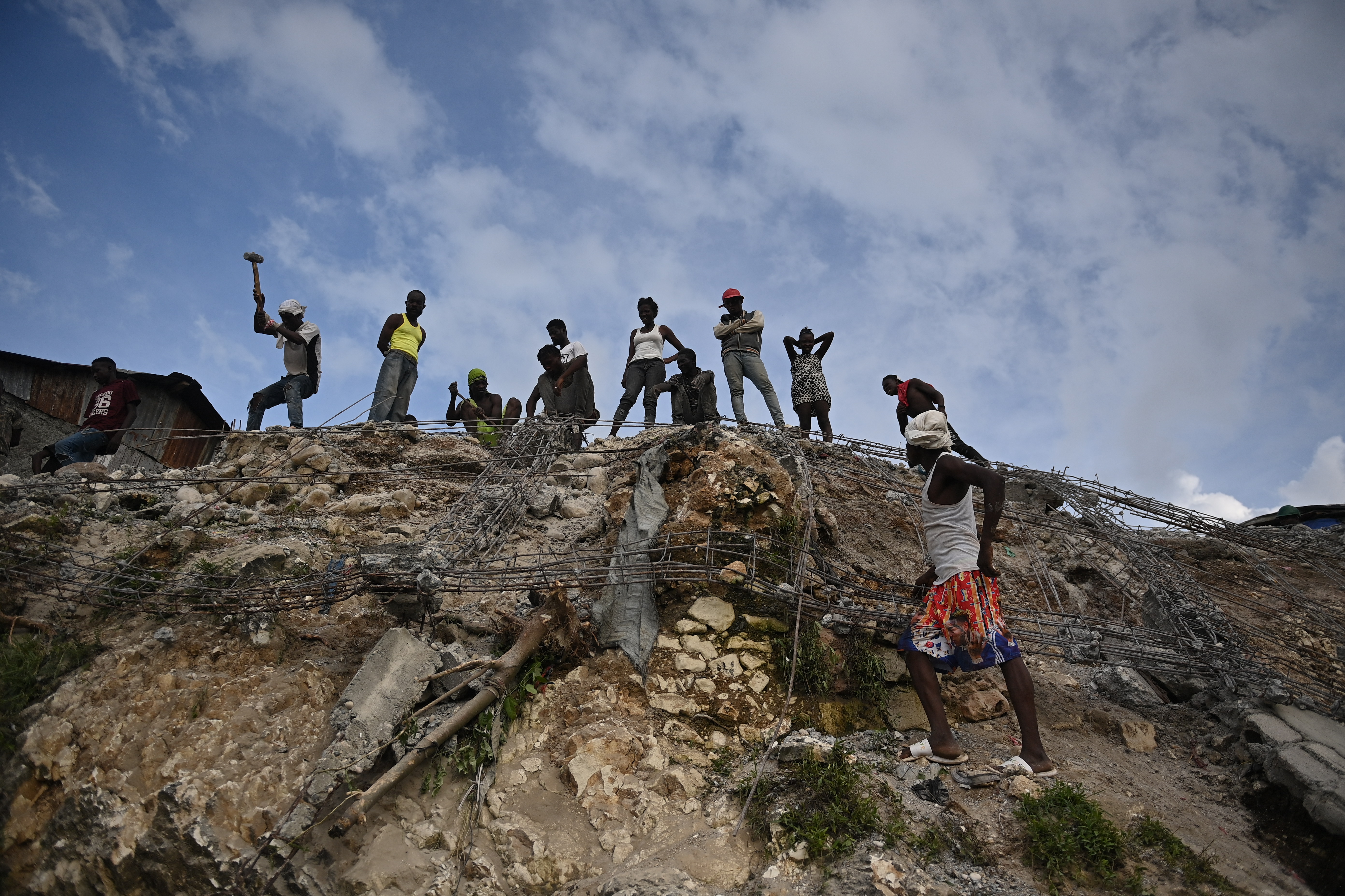 People work amongst debris in Jeremie, Haiti