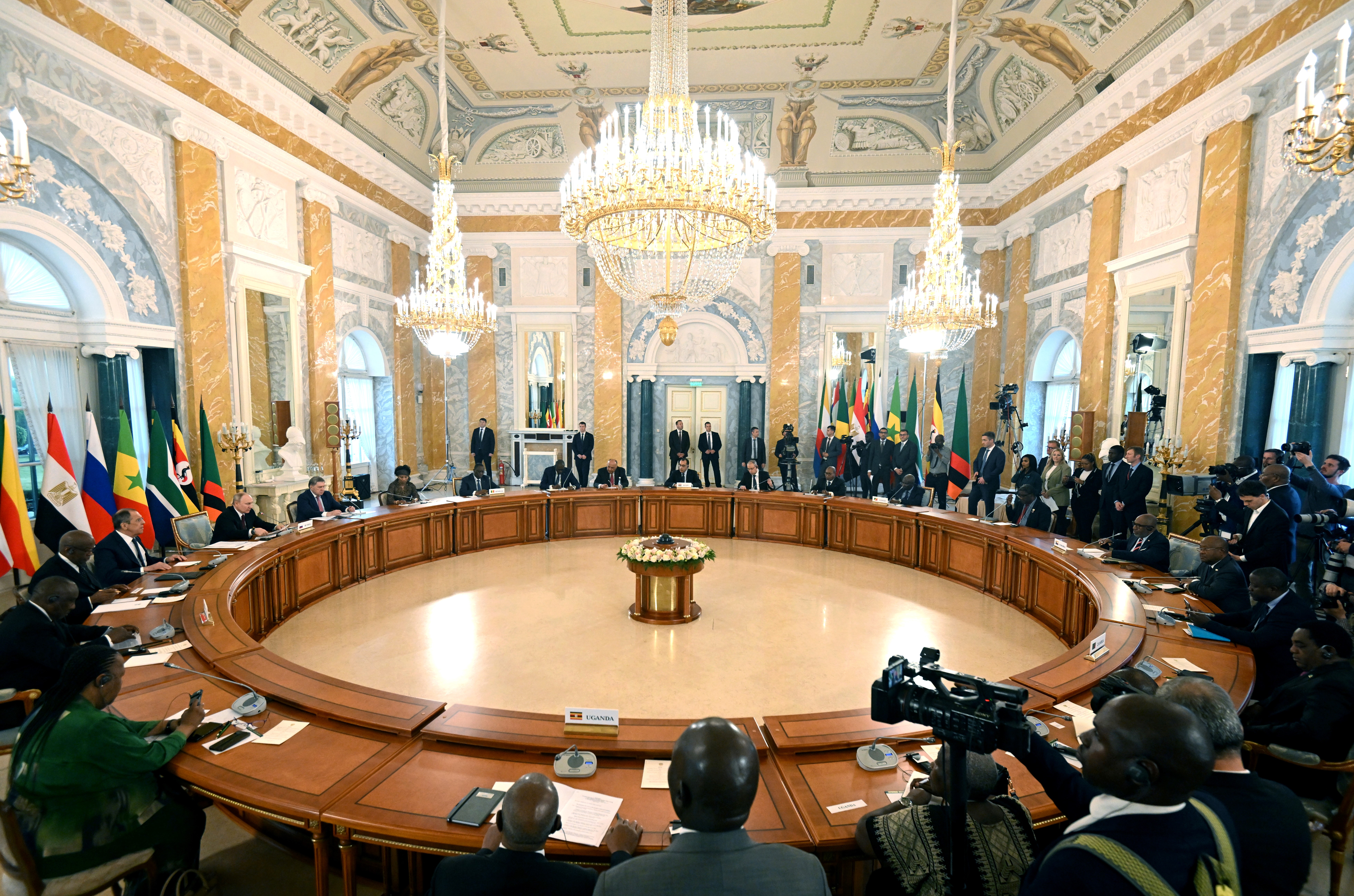 This handout picture taken by RIA Novosti on June 17, 2023 shows Russian President Vladimir Putin (L) attending a meeting with delegations of African leaders at the Constantine (Konstantinovsky) Palace in Strelna, outside Saint Petersburg