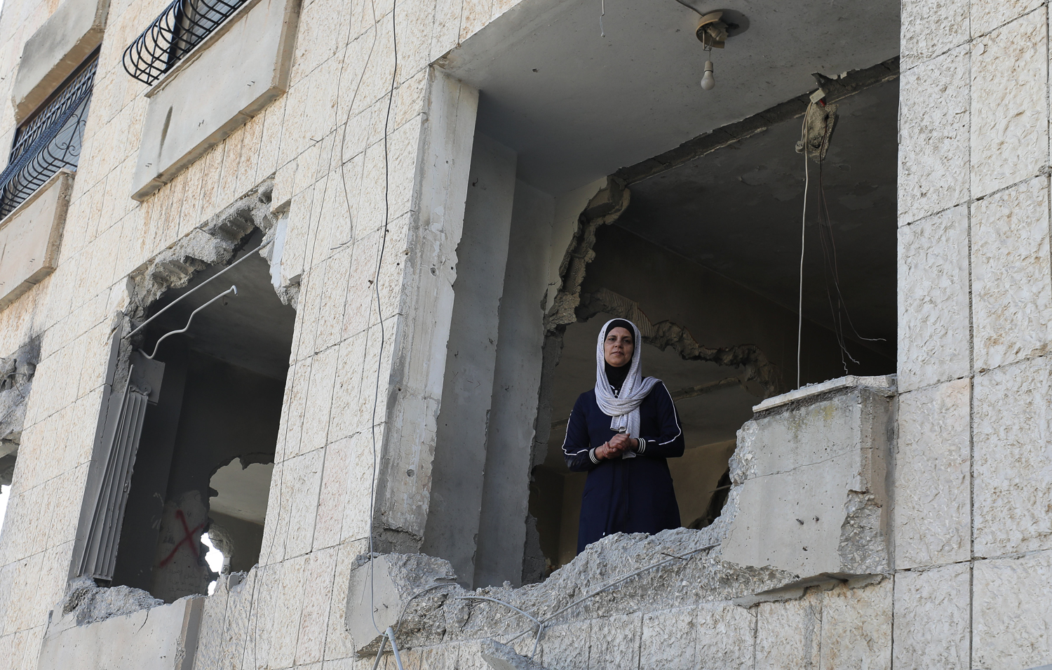 Tamara al-Jouri looks at wreckage of his home, which was destroyed by Israeli soldiers overnight Thursday, in Nablus, West Bank [Ayman Nobani/Al Jazeera]