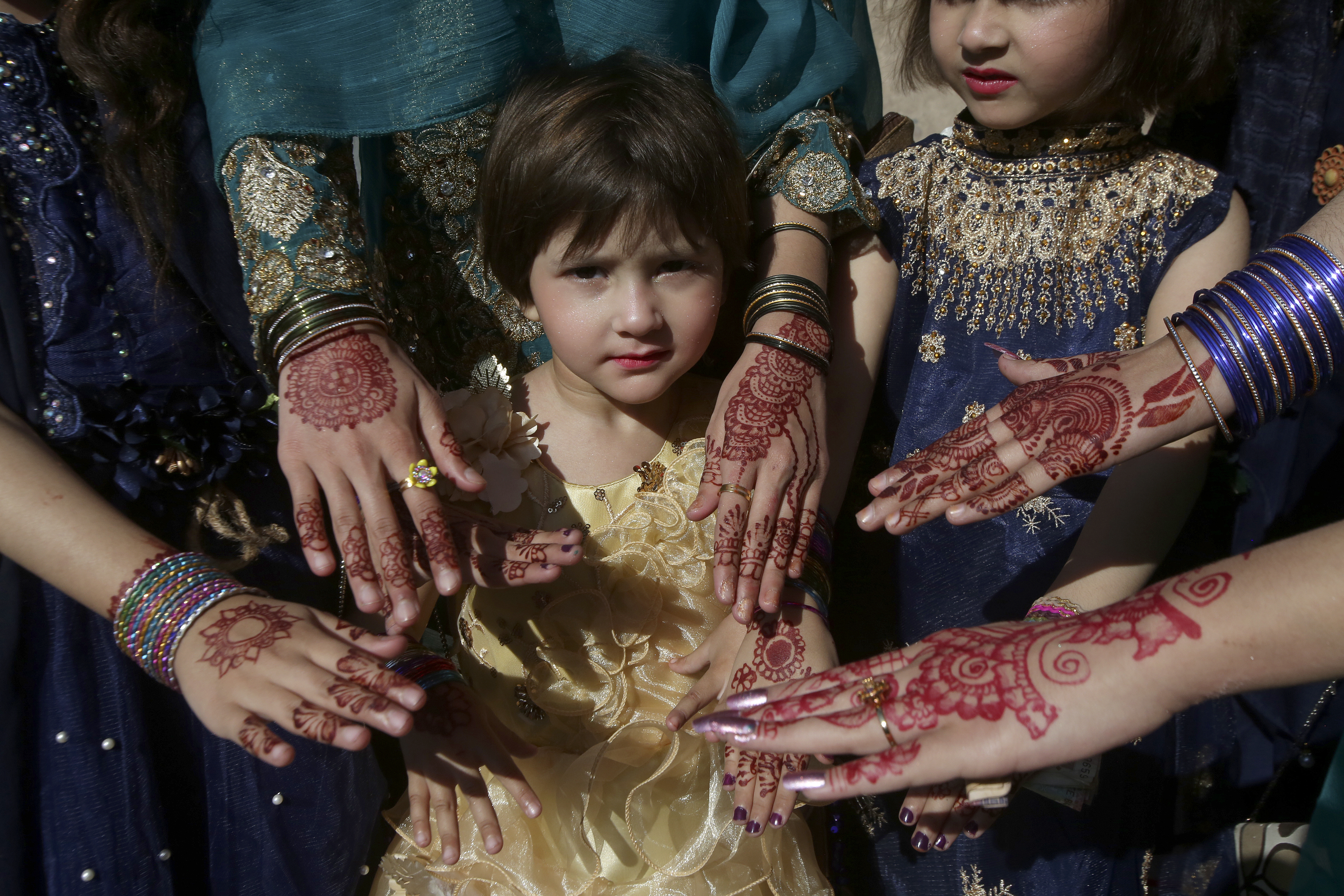 Muslim girls display their hands painted with traditional "henna" as they celebrate Eid, in Peshawar, Pakistan 