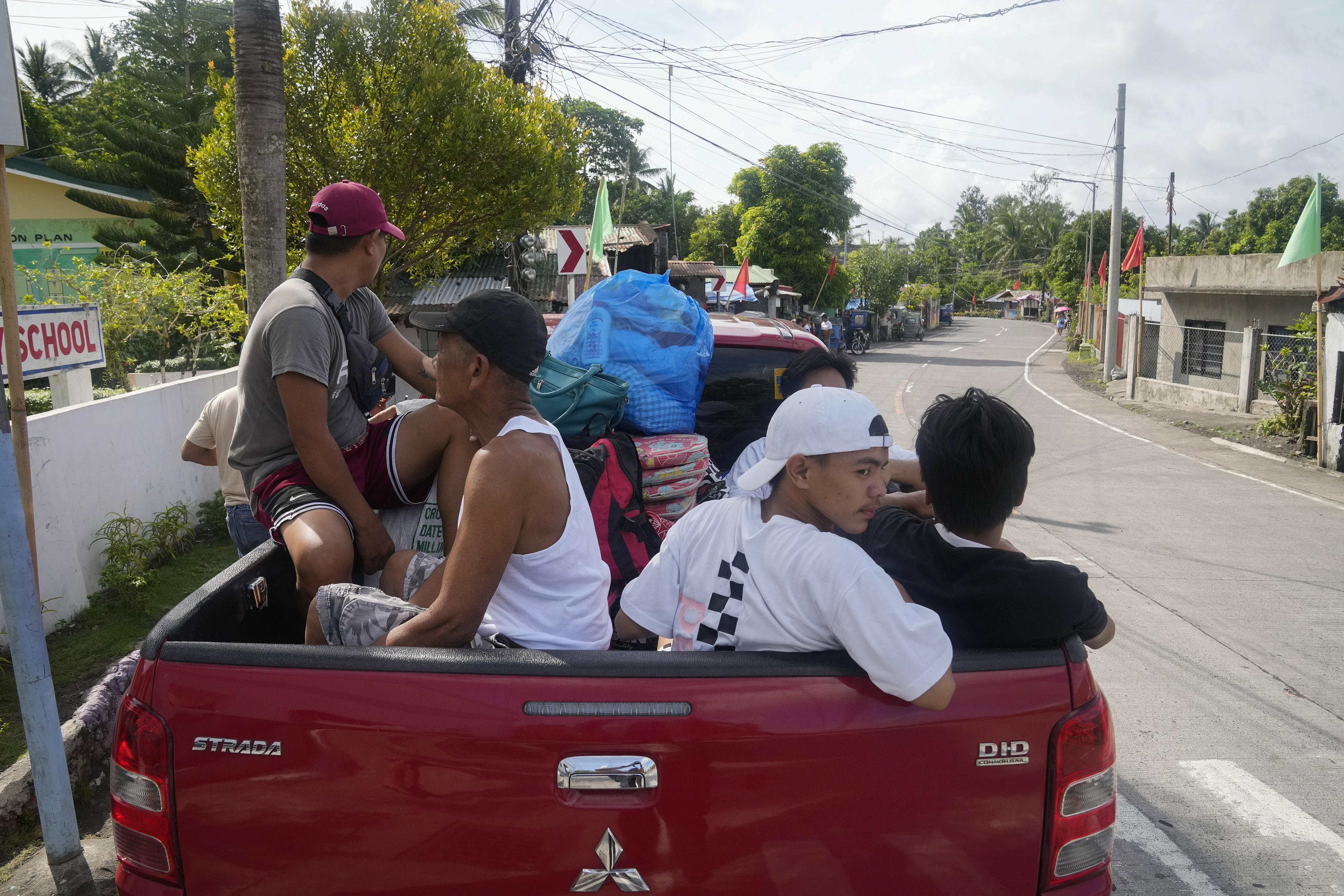 Residents living near the Mayon volcano leave their homes as they evacuate to safer grounds in Daraga town