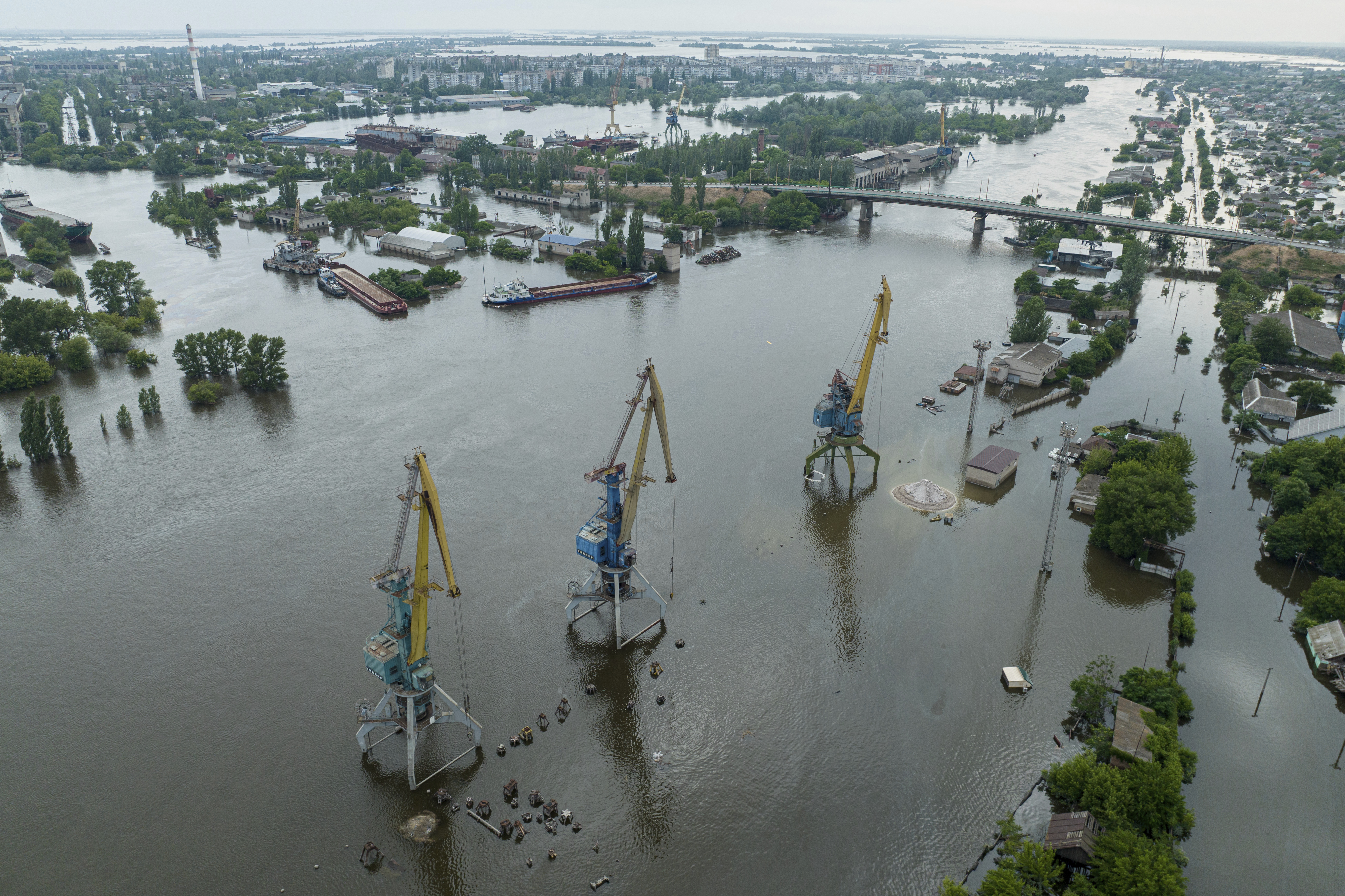 Streets and trade port are seen underwater and polluted by oil in the flooded Kherson