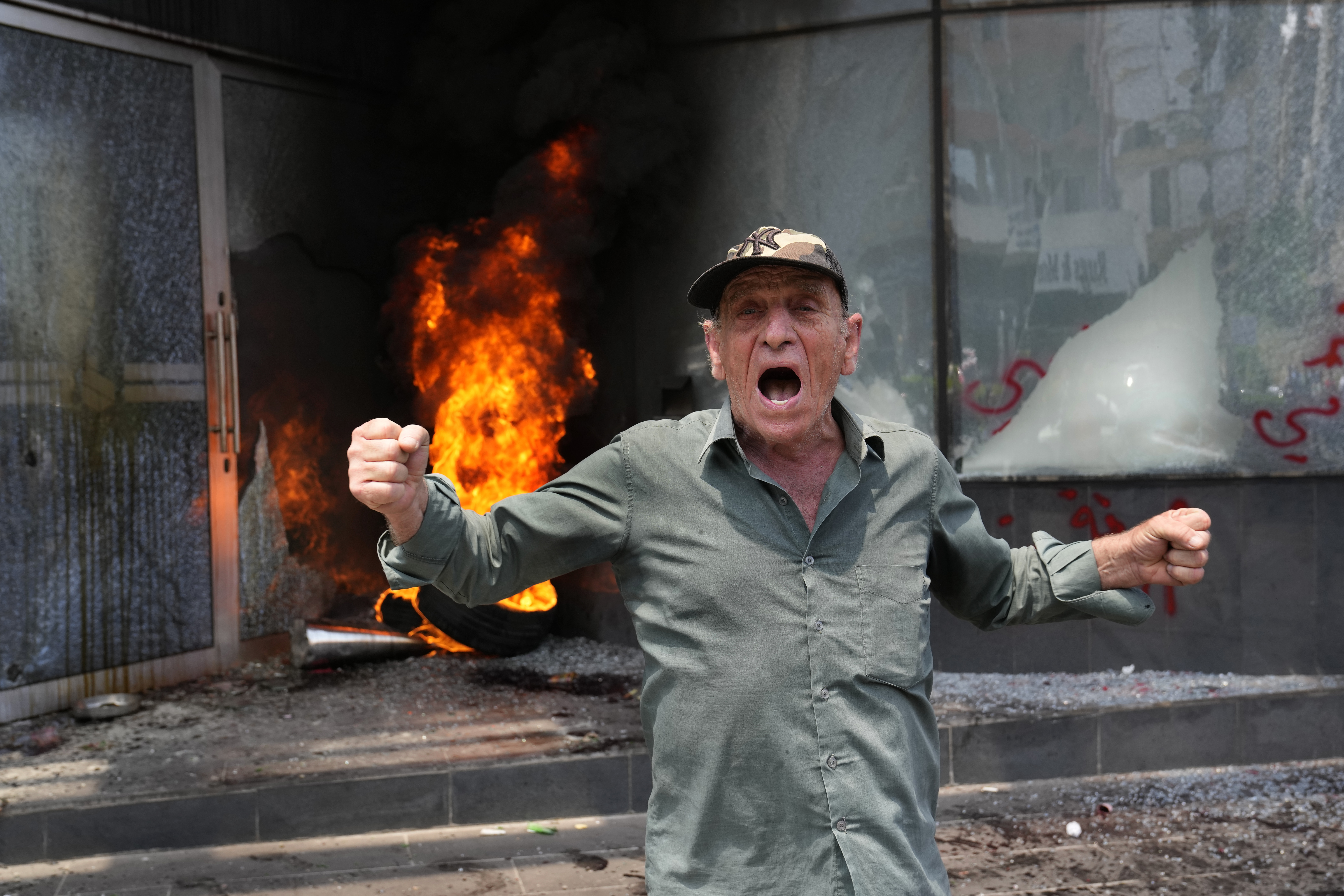 A protester shouts slogans outside Byblos Bank during a protest demanding the release of depositors' trapped savings, in Beirut, Lebanon