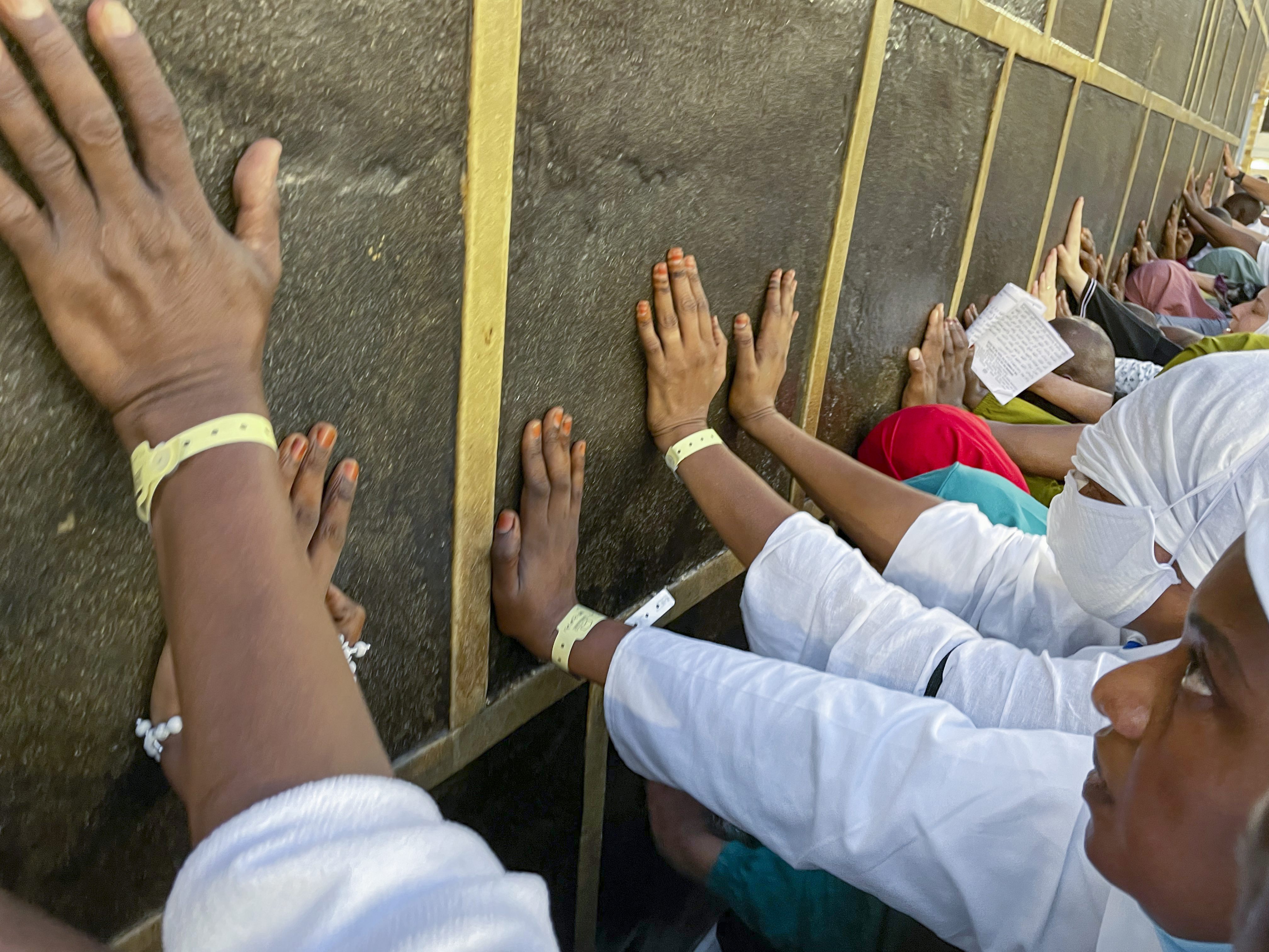 Muslim pilgrims pray in front of the Kaaba