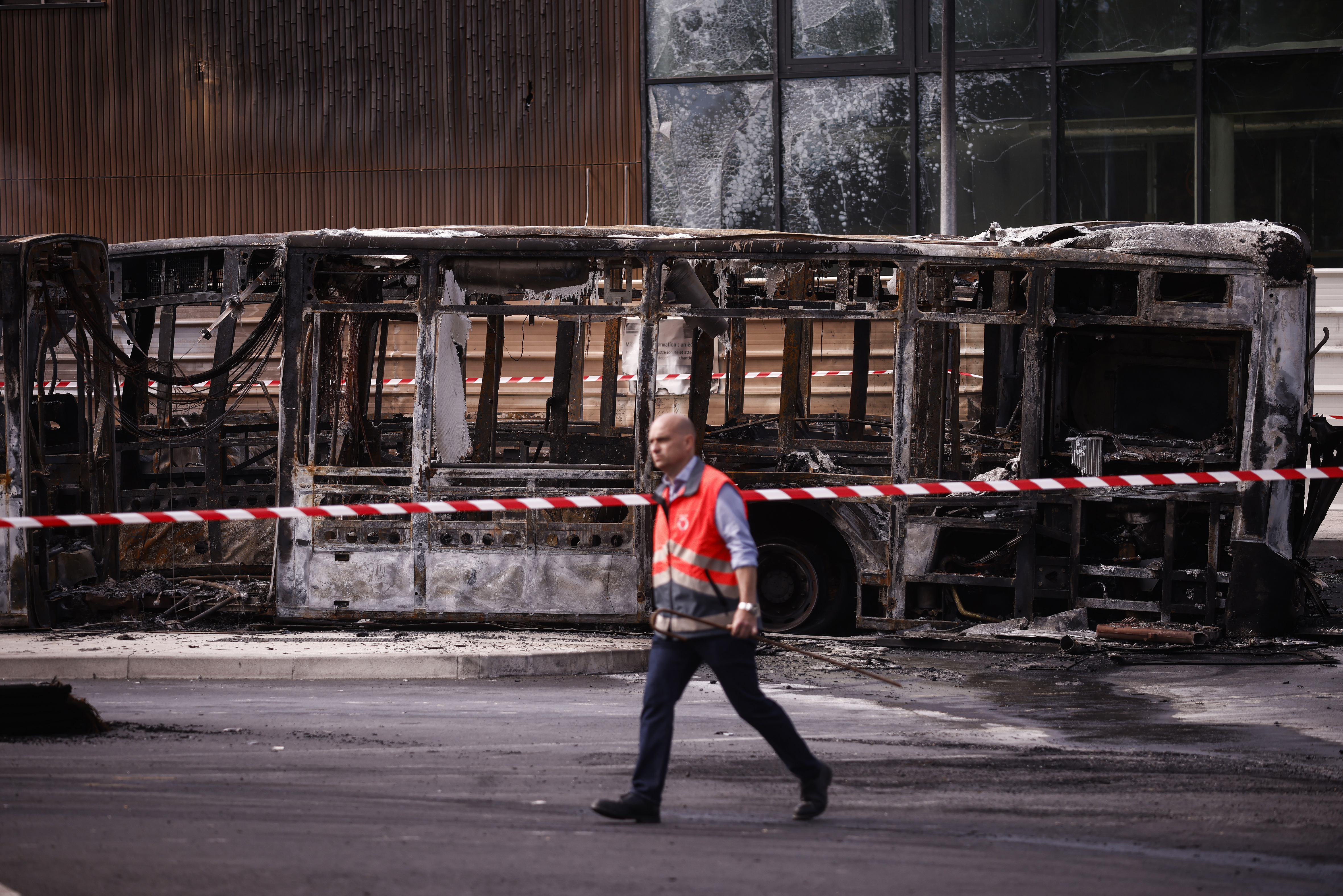 Charred buses that were burned at a public transport site in Aubervilliers, near Paris [Yoan Valet/EPA-EFE]