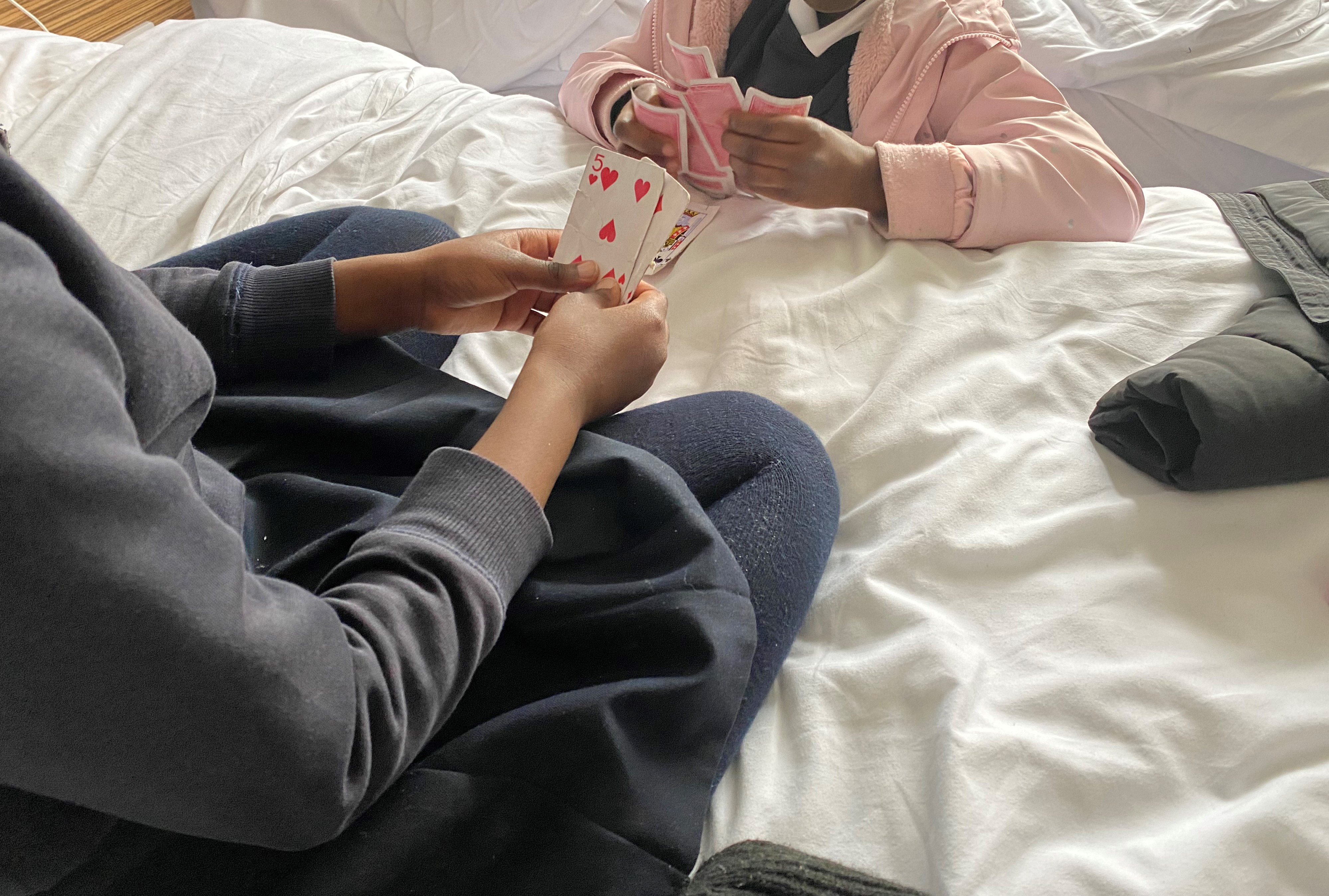 Two girls play cards
