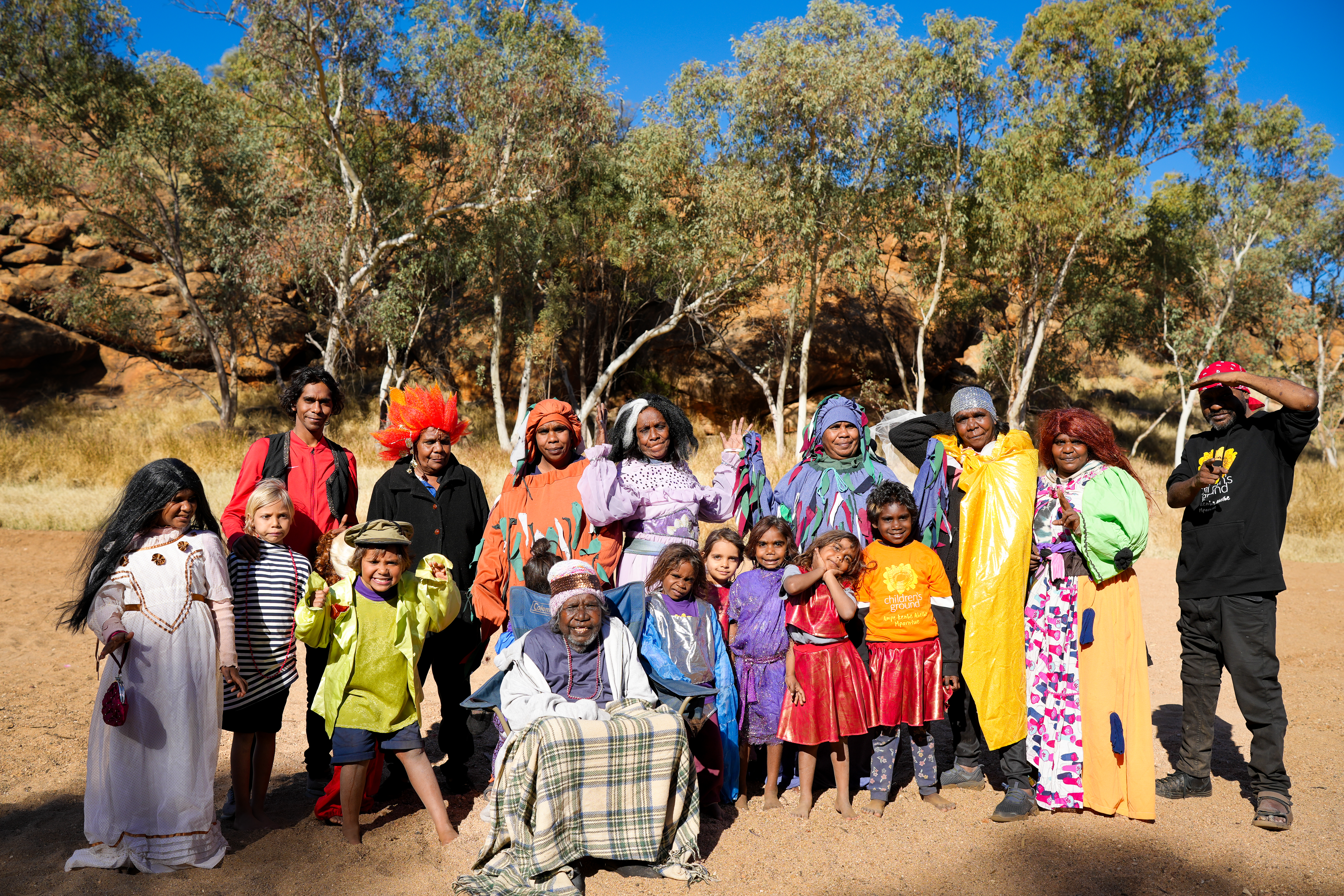 Aboriginal women and children in a group photo taken outside.