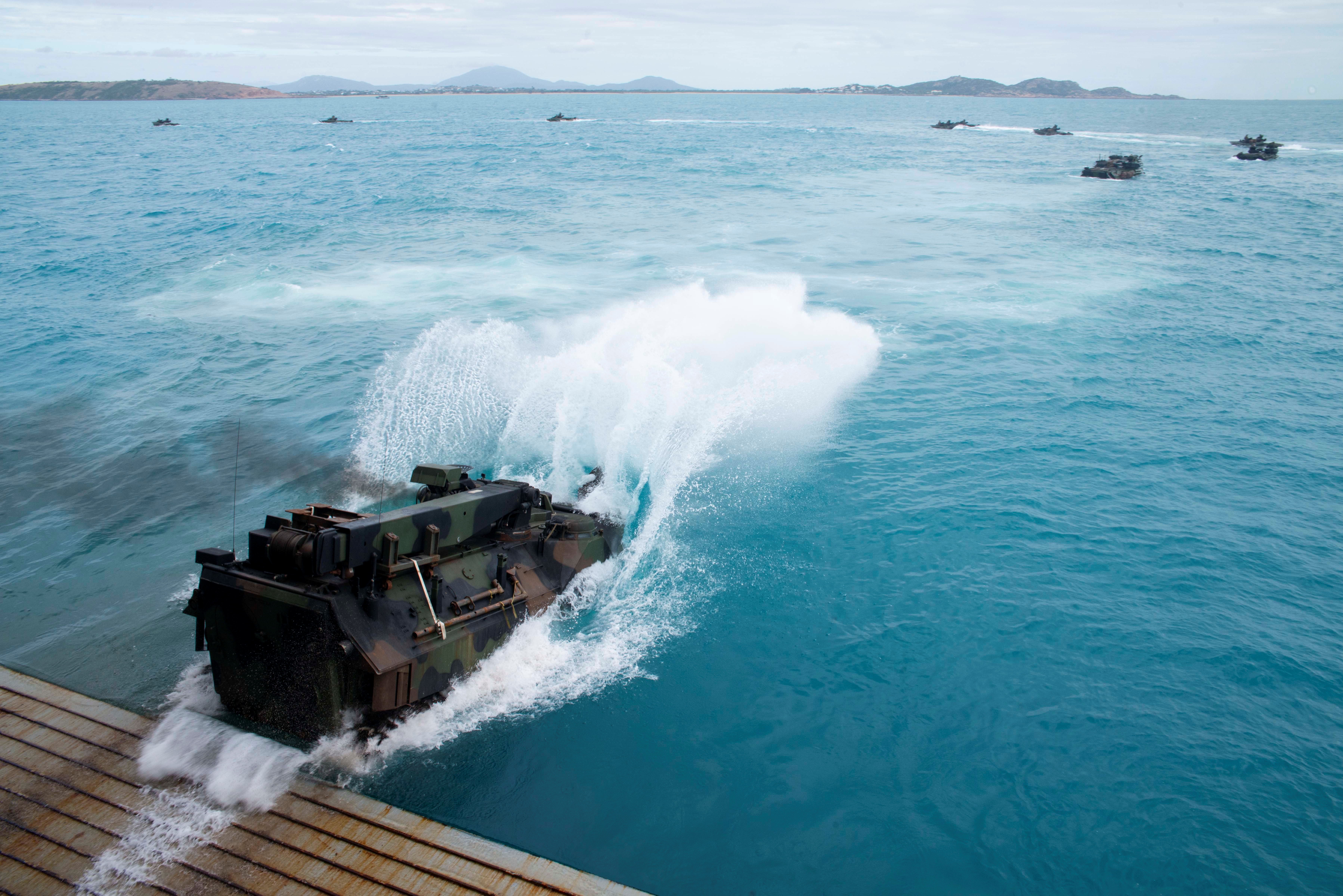 U.S. Marines assault amphibious vehicles, depart the well deck of the amphibious transport dock ship USS Green Bay, during the Talisman Sabre 2019, a U.S. and Australian biennial training event off the coast of Northern Australia in Bowen, Australia
