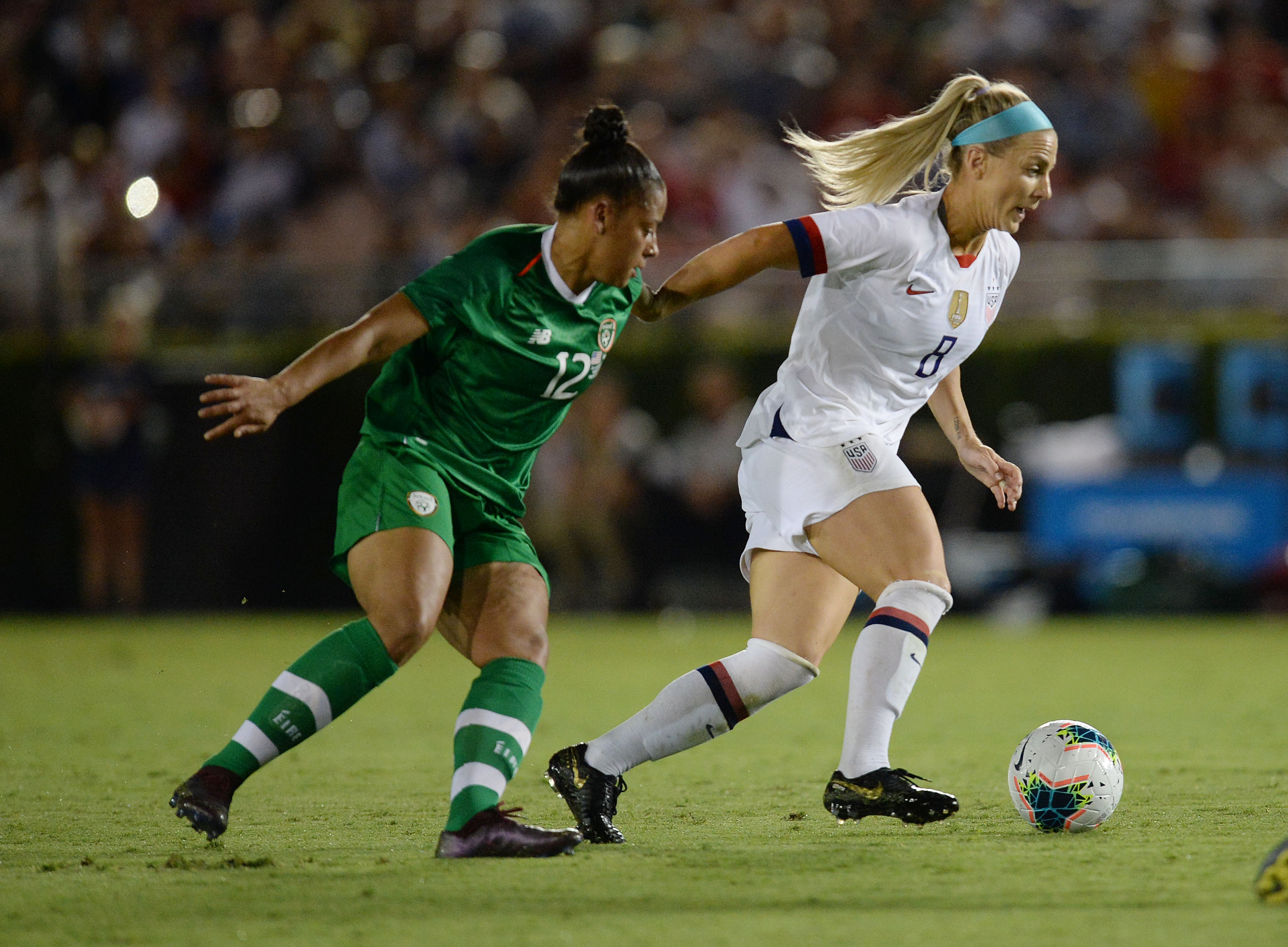 Rianna Jarrett (left) challenges a ball against US midfielder Julie Ertz