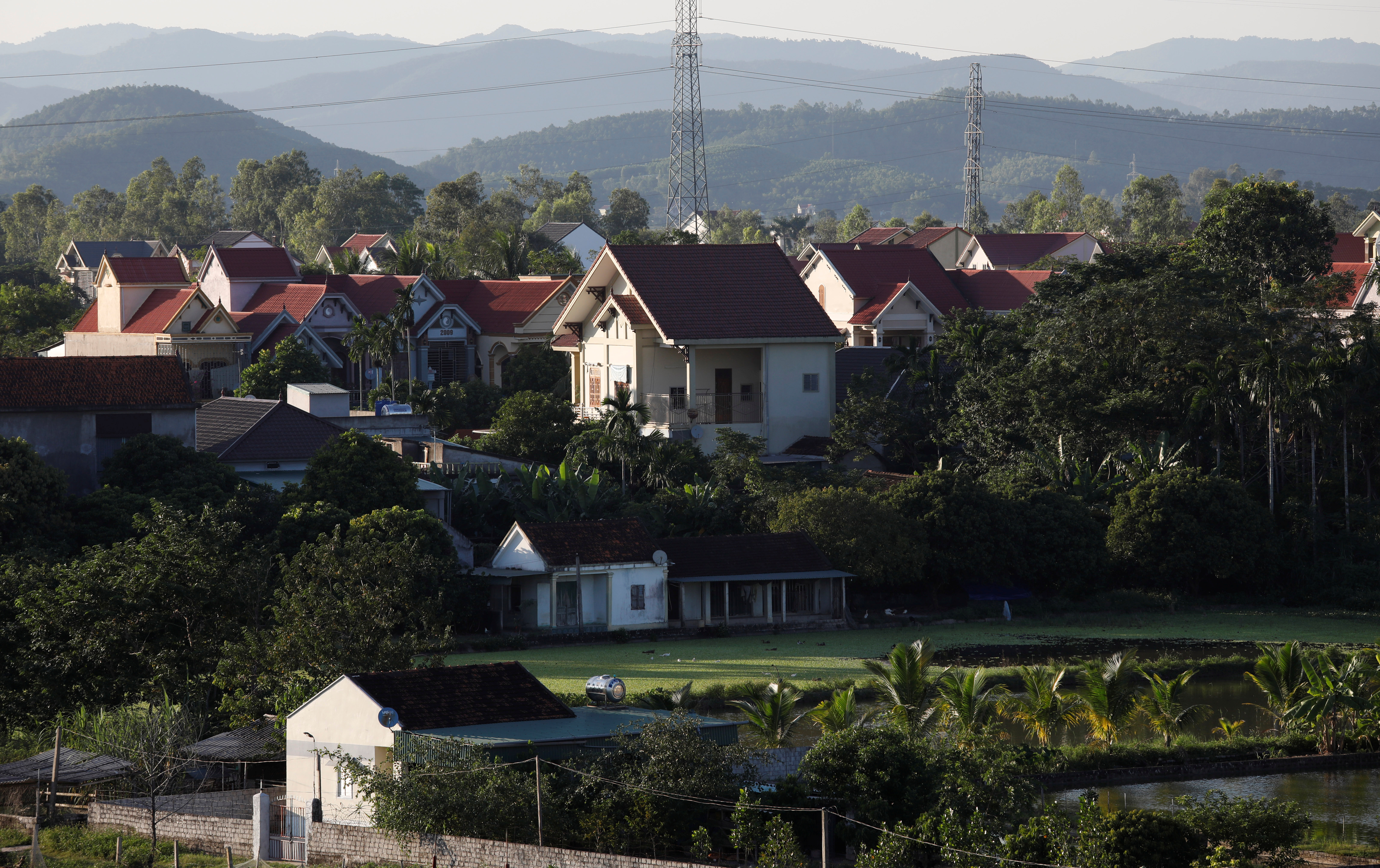 Newly-built houses are seen behind older houses at Do Thanh commune, in Nghe An province, Vietnam October 29, 2019. Picture taken October 29, 2019. REUTERS/Kham