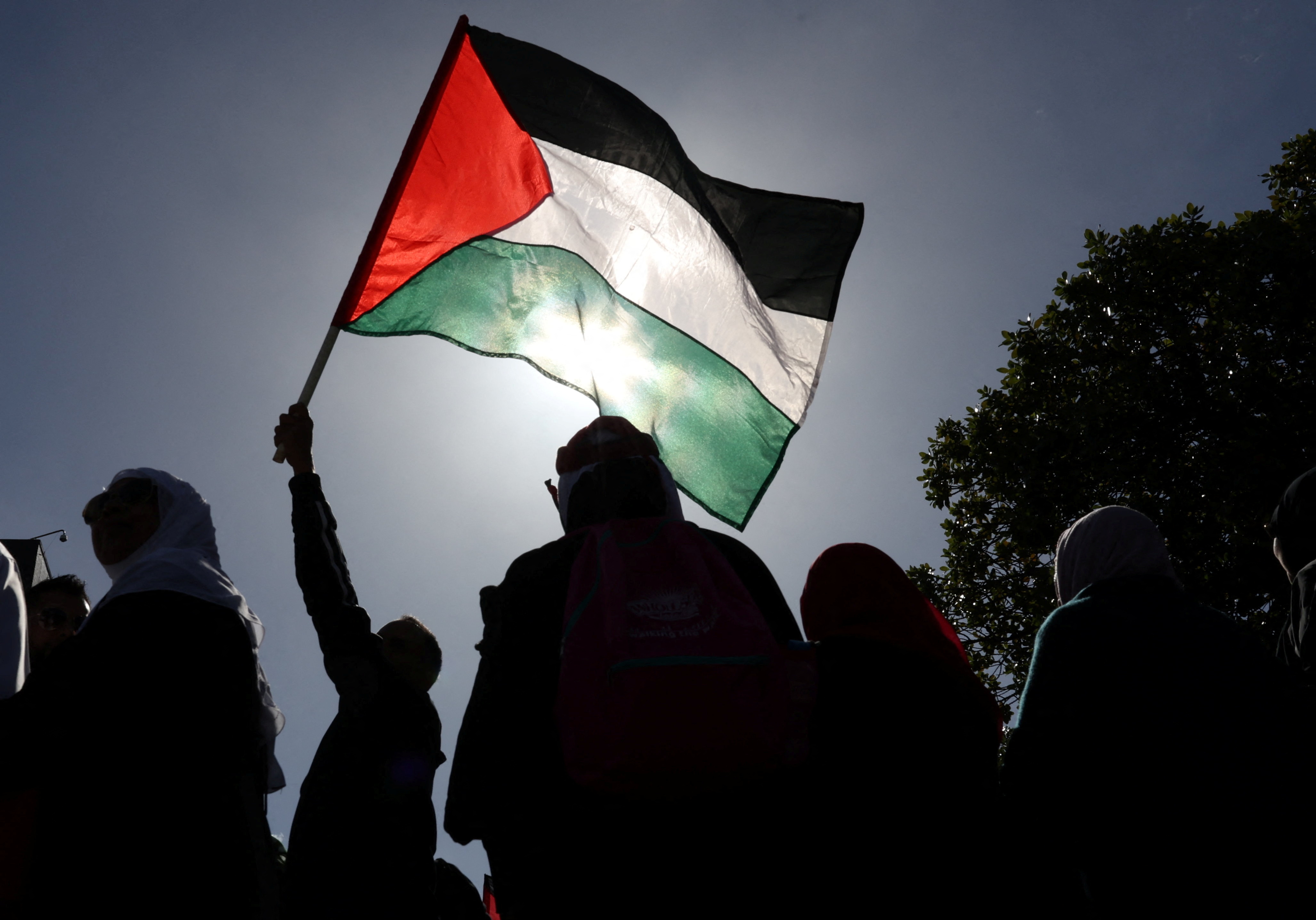 A person hold a Palestinian flag during the annual al-Quds day (Jerusalem Day), during the month of Ramadan in Cape Town, South Africa, April 14, 2023. REUTERS/Esa Alexander