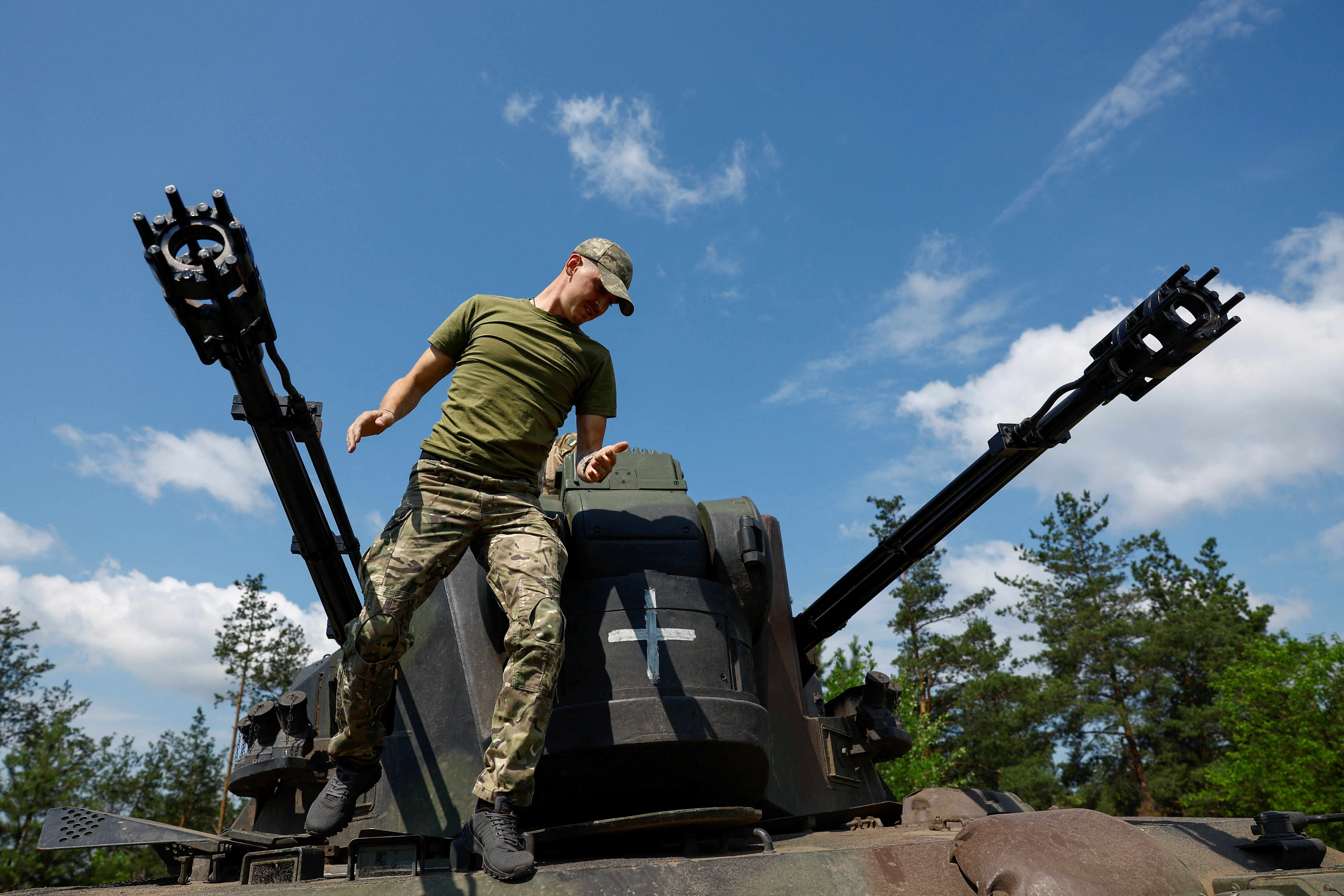 A Ukrainian serviceman jumps from a Gepard self-propelled anti-aircraft gun during his combat shift, amid Russia's attack on Ukraine, in Kyiv region, Ukraine June 30, 2023. REUTERS/Valentyn Ogirenko