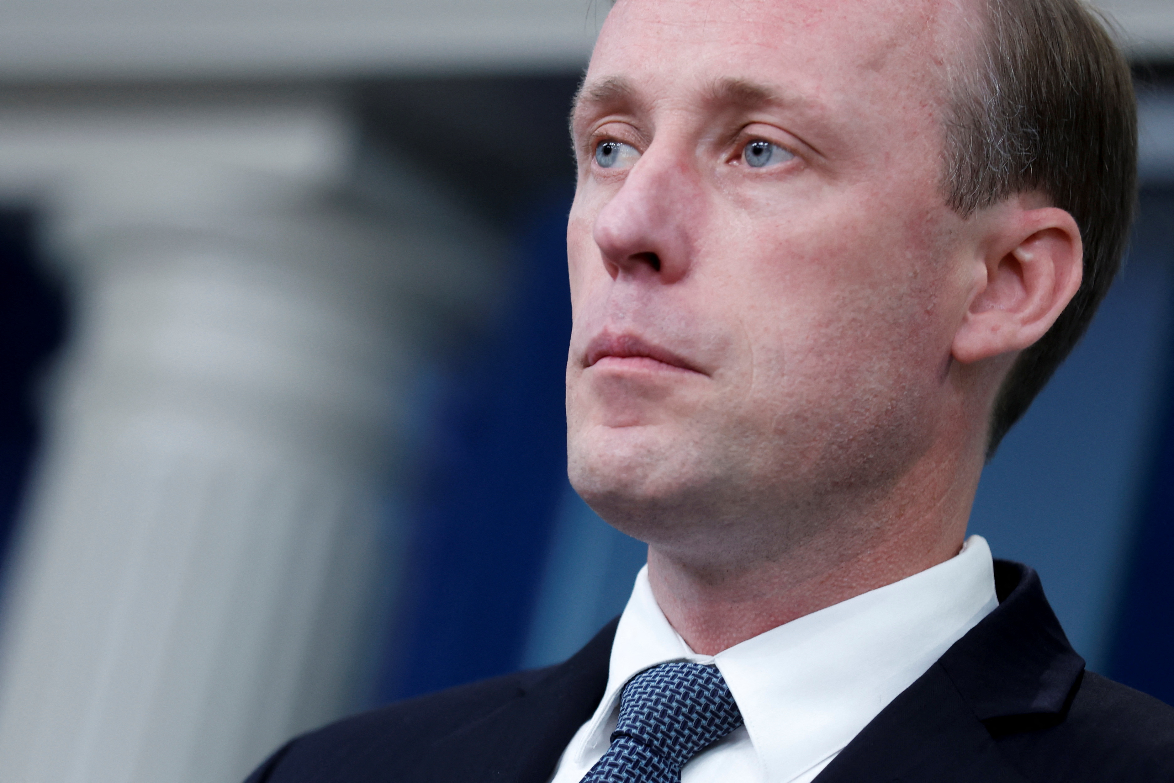 A close-up of Jake Sullivan, in a dark suit and tie.