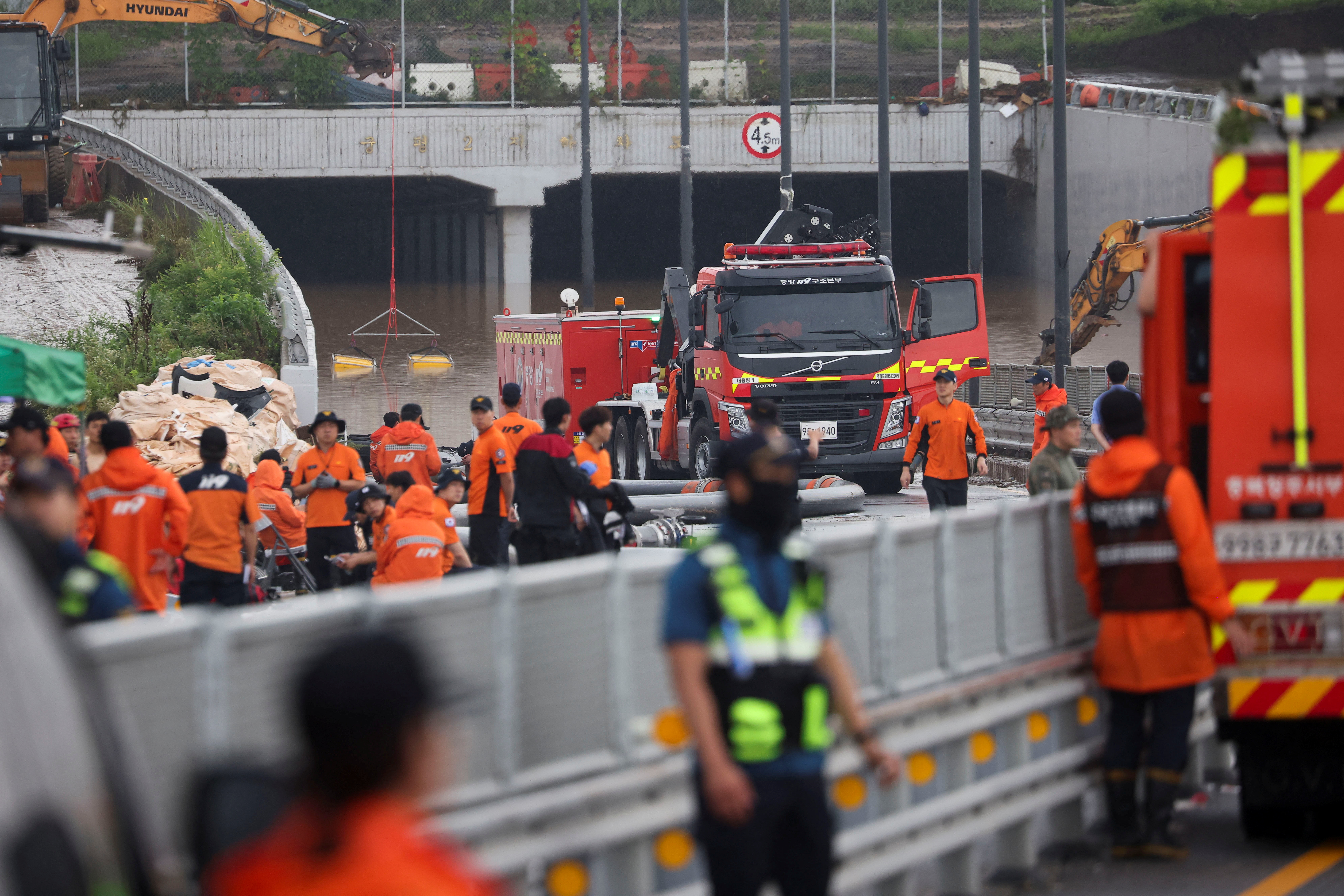 Rescue workers take part in a search and rescue operation at an underpass that has been submerged by an flooded river caused by torrential rain in Cheongju, South Korea, July 16, 2023.