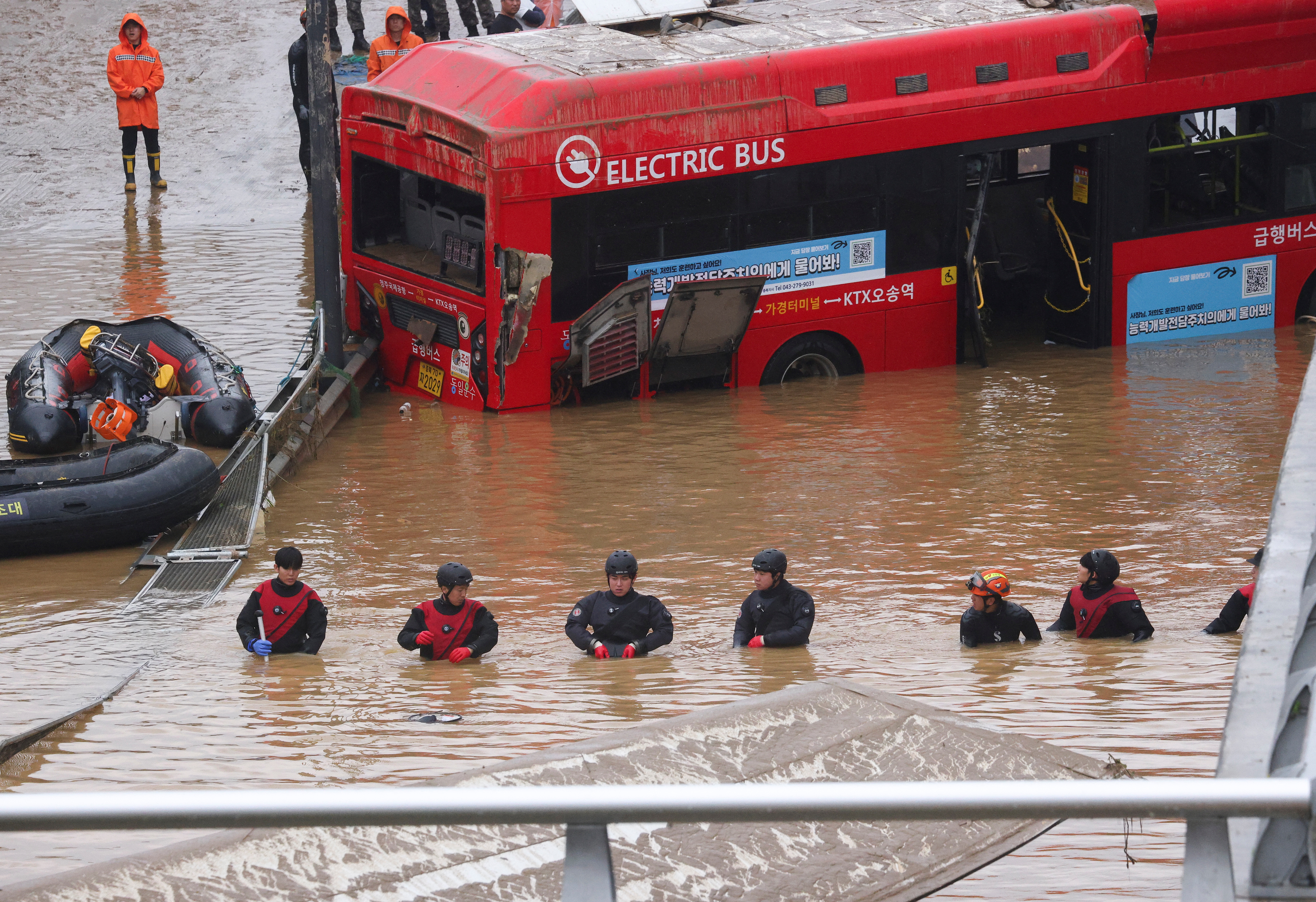 Rescue workers take part in a search and rescue operation near an underpass that has been submerged by a flooded river caused by torrential rain in Cheongju, South Korea, July 16, 2023.