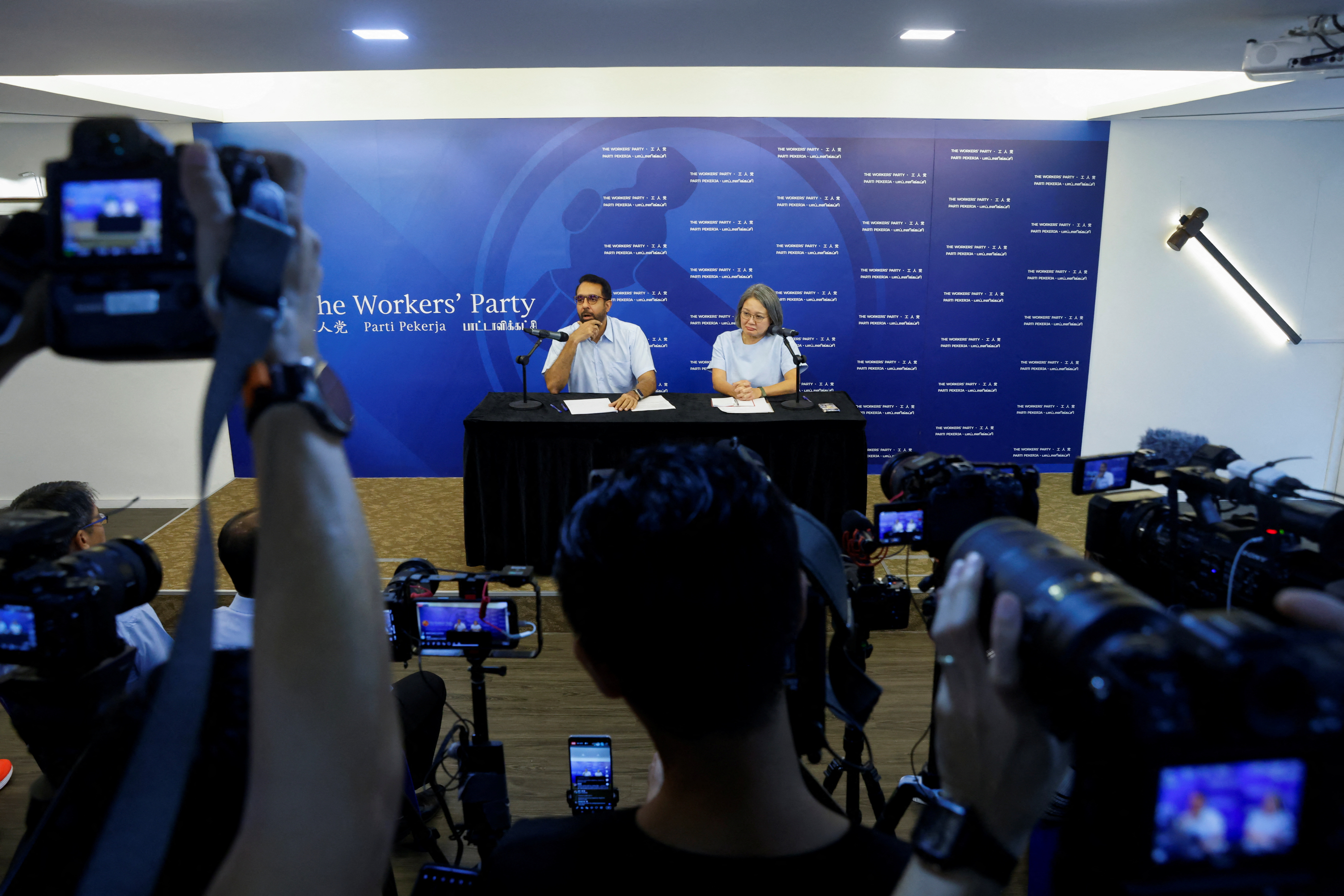 Workers' Party chief Sylvia Lim and secretary-general Pritam Singh attend a news conference at the party office in Singapore,