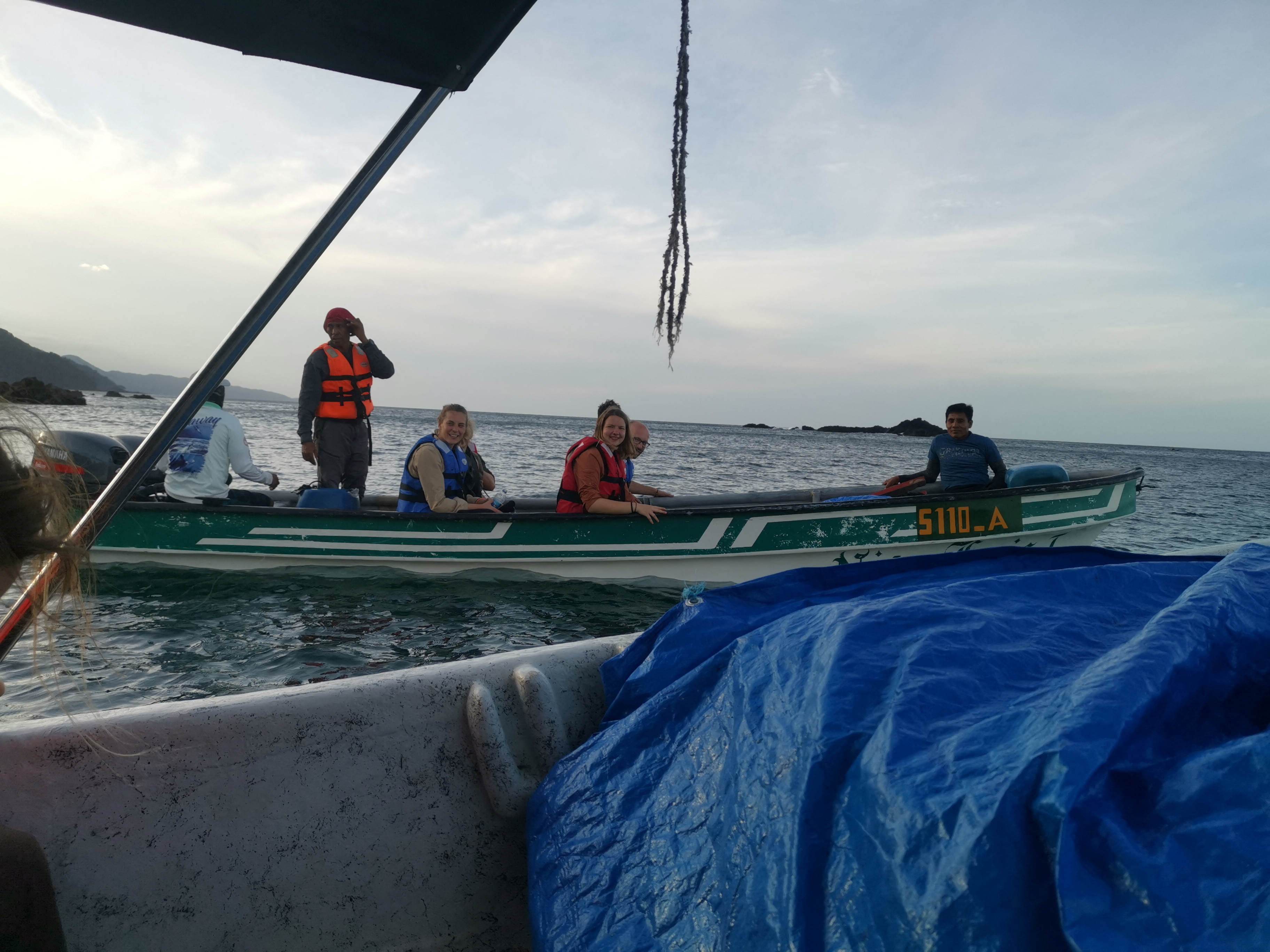 People sit in a boat during an excursion through the Darien Gap region