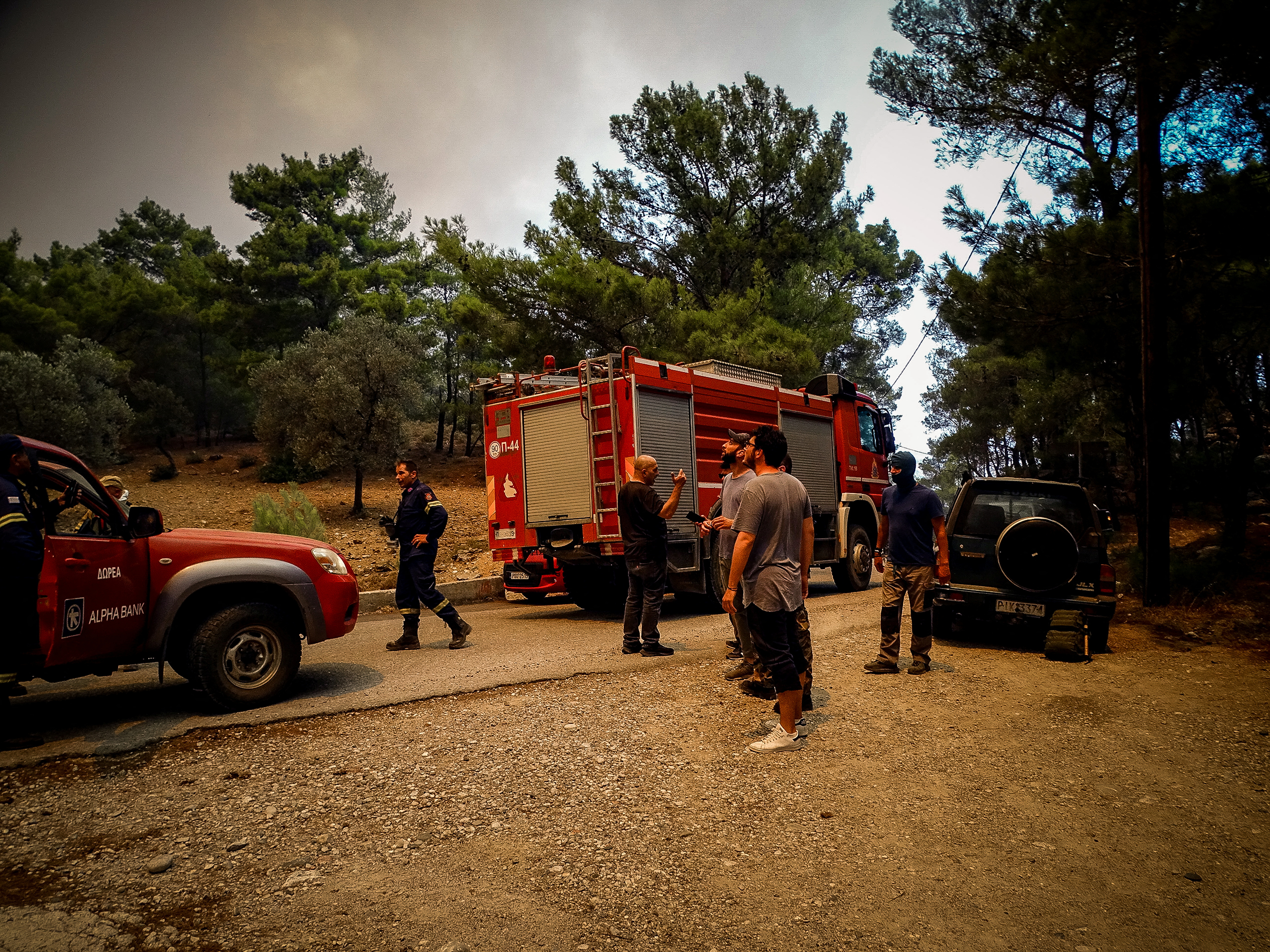 Firefighters are seen near a wildfire on the island of Rhodes