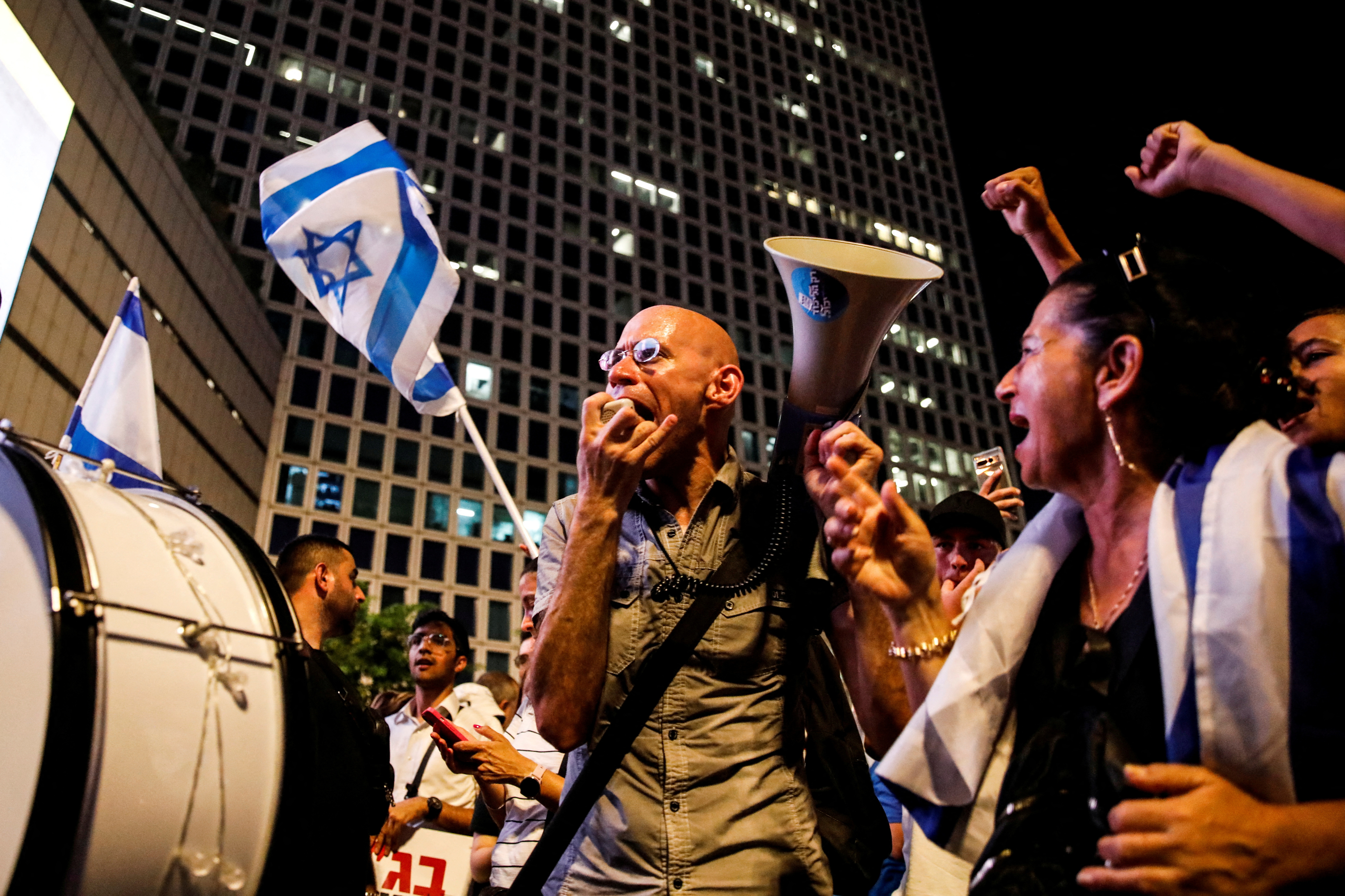 People take part in a demonstration supporting Israeli Prime Minister Benjamin Netanyahu and his nationalist coalition government's judicial overhaul, in Tel Aviv, Israel