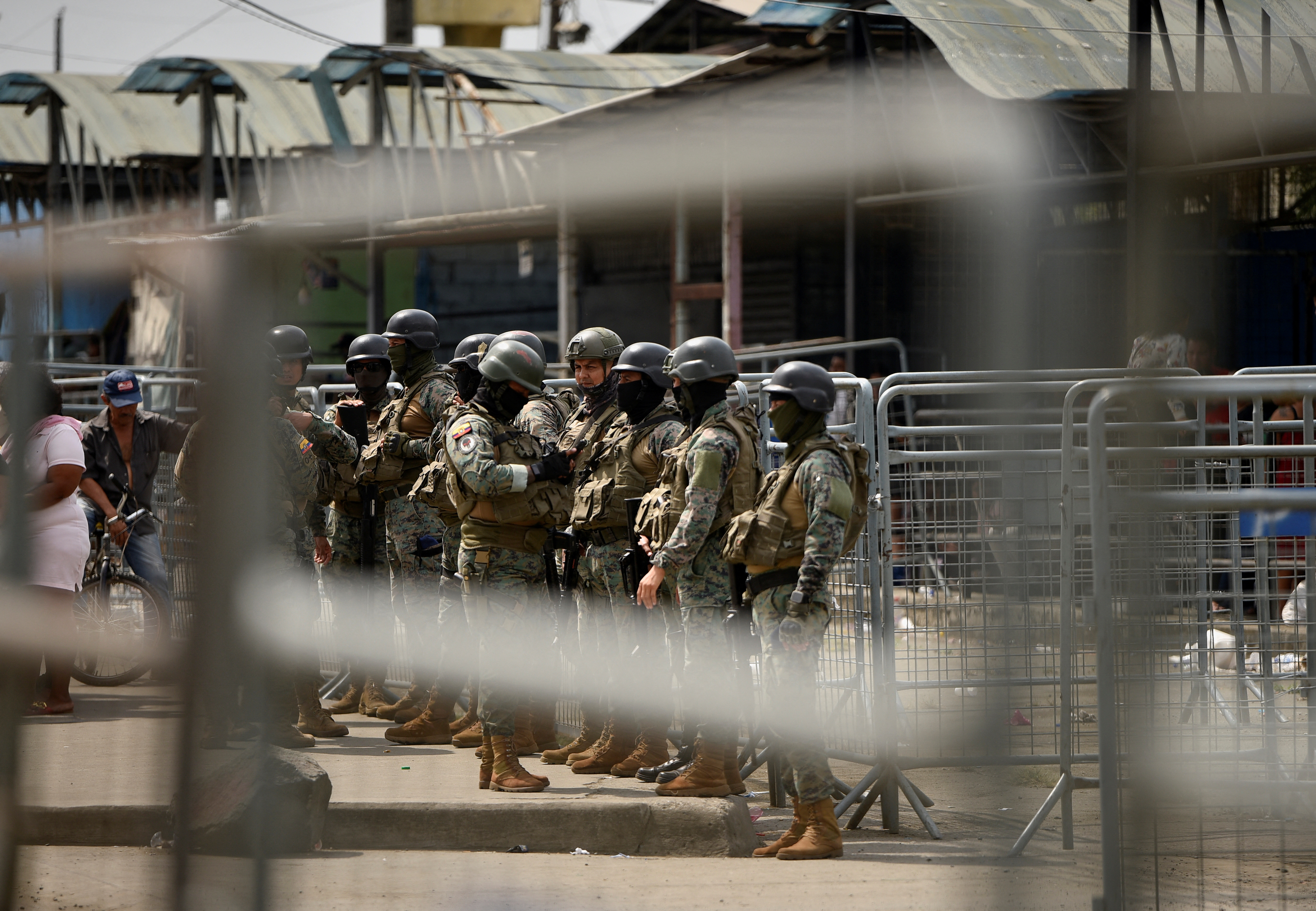 Ecuador security forces stand guard outside a prison
