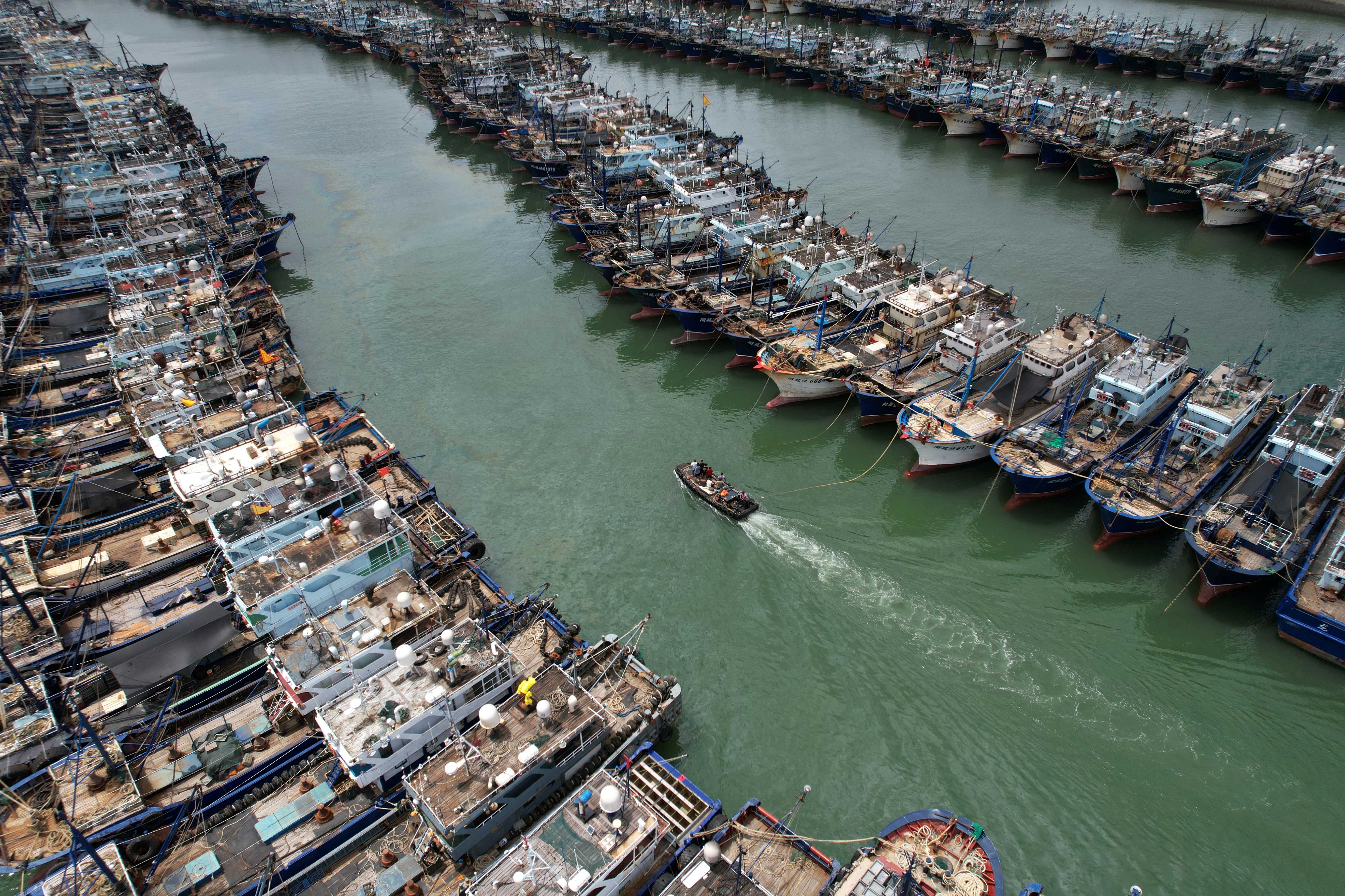 Fishing boats are seen moored at Gaoqi fishing port as typhoon Doksuri approaches, in Xiamen, Fujian province, China July 26, 2023. 