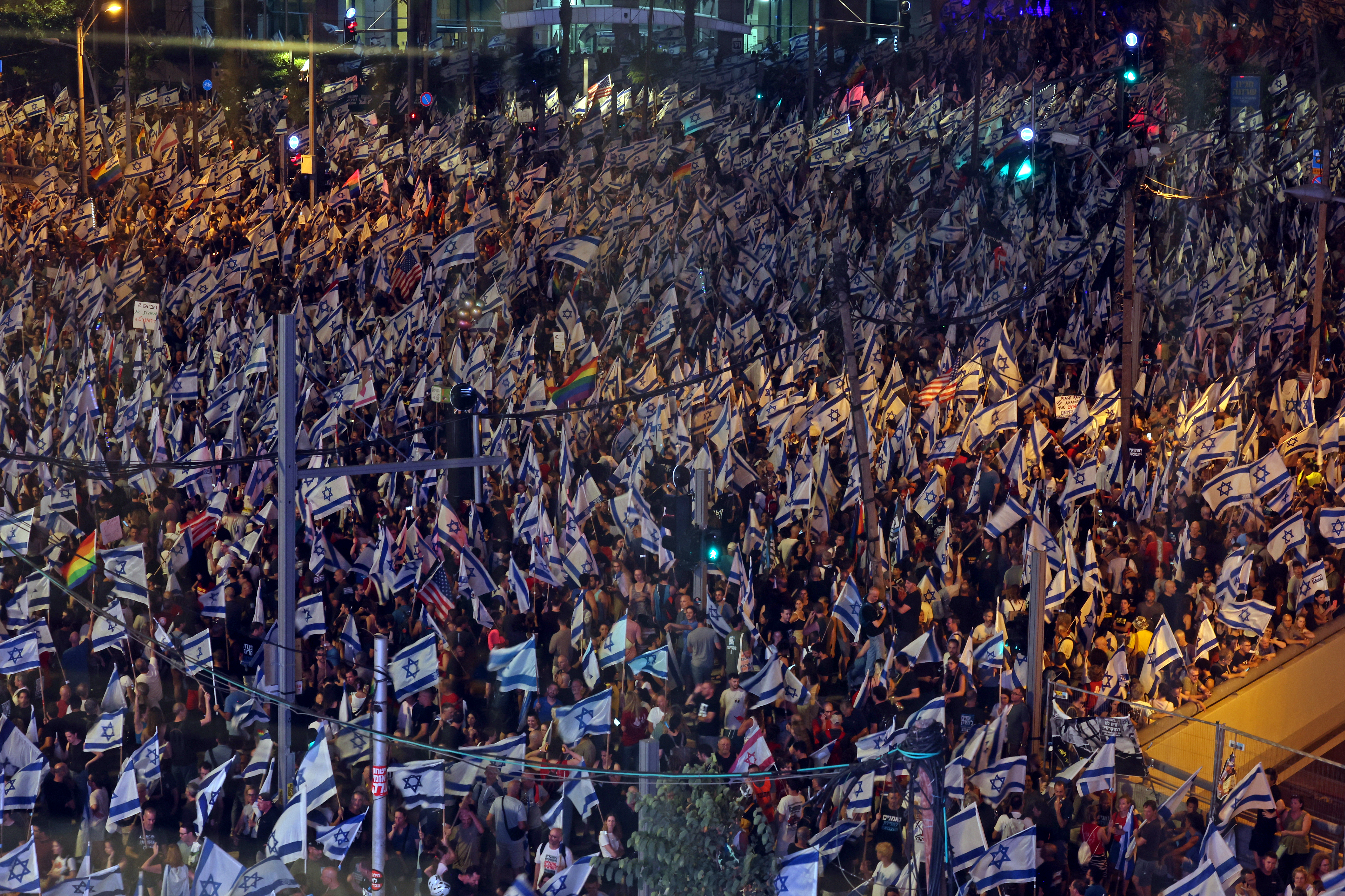 Demonstrators march with Israeli flags