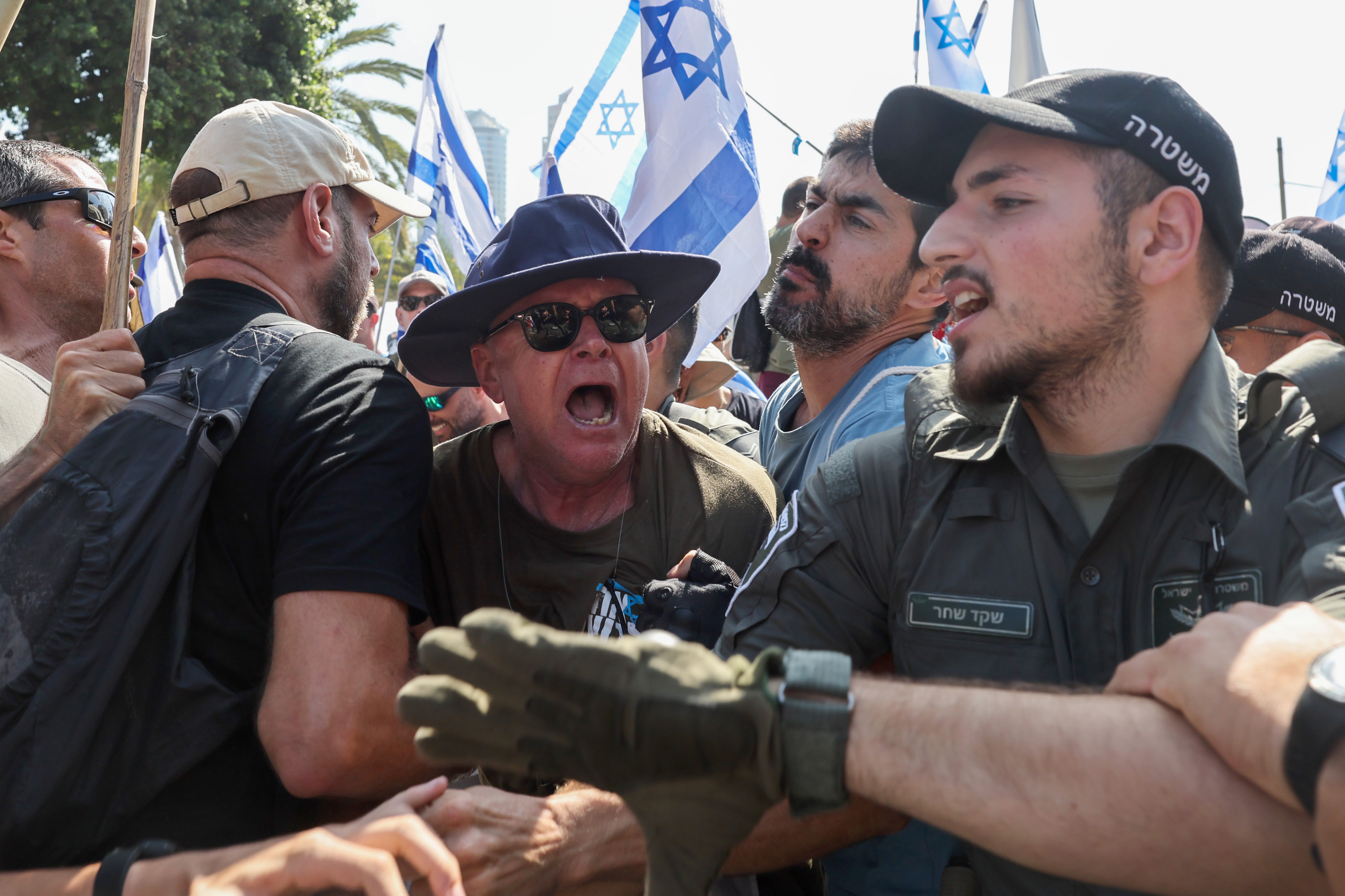 Members of Israeli security forces scuffle with demonstrators during a 'day of resistance' to protest the Israeli government's judicial overhaul bill, in Tel Aviv on July 18, 2023. - The proposals have divided the nation and triggered one of the biggest protest movements in Israel's history since being unveiled in January by the hard-right government of Prime Minister Benjamin Netanyahu. (Photo by JACK GUEZ / AFP)