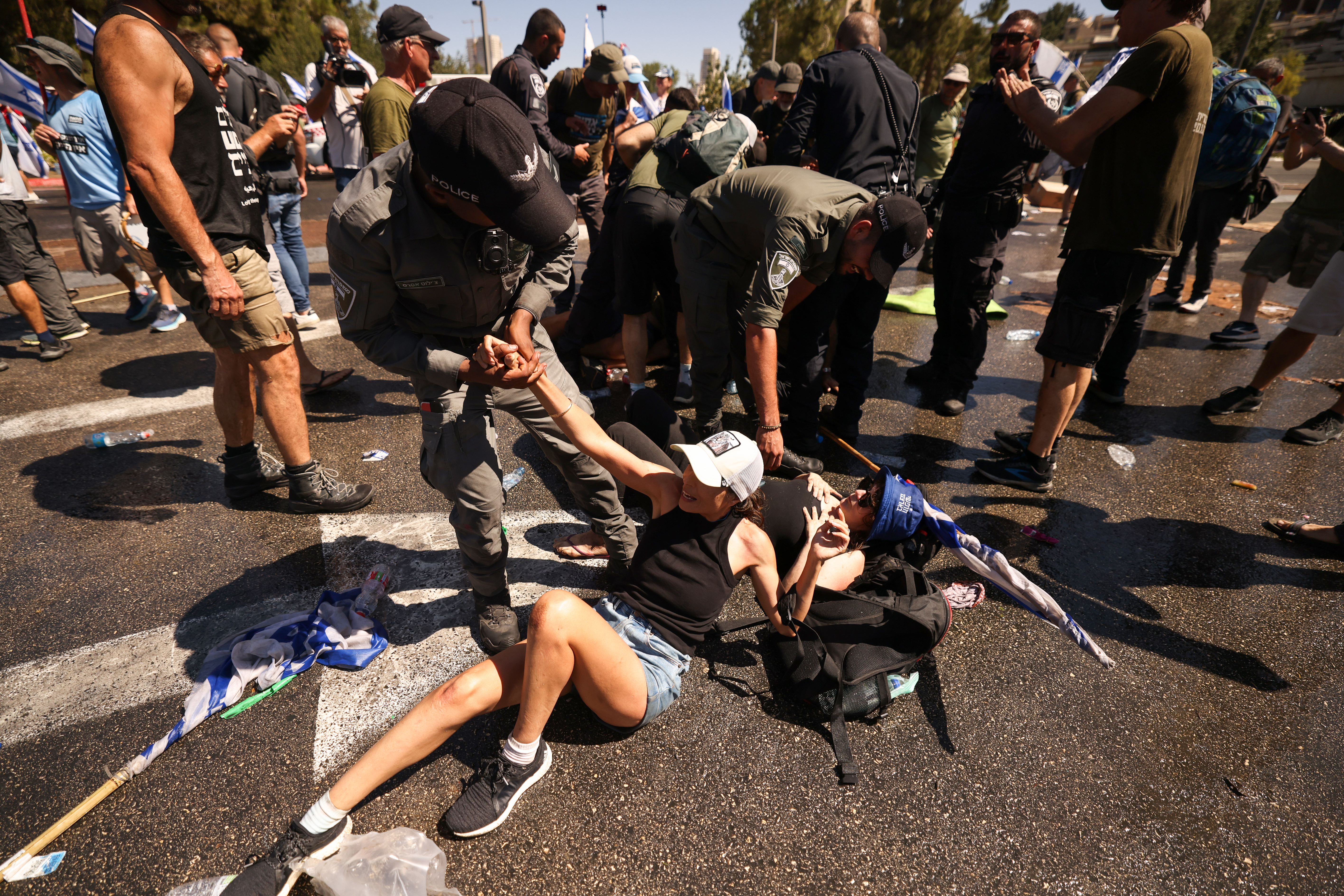 Members of Israel's security forces remove demonstrators
